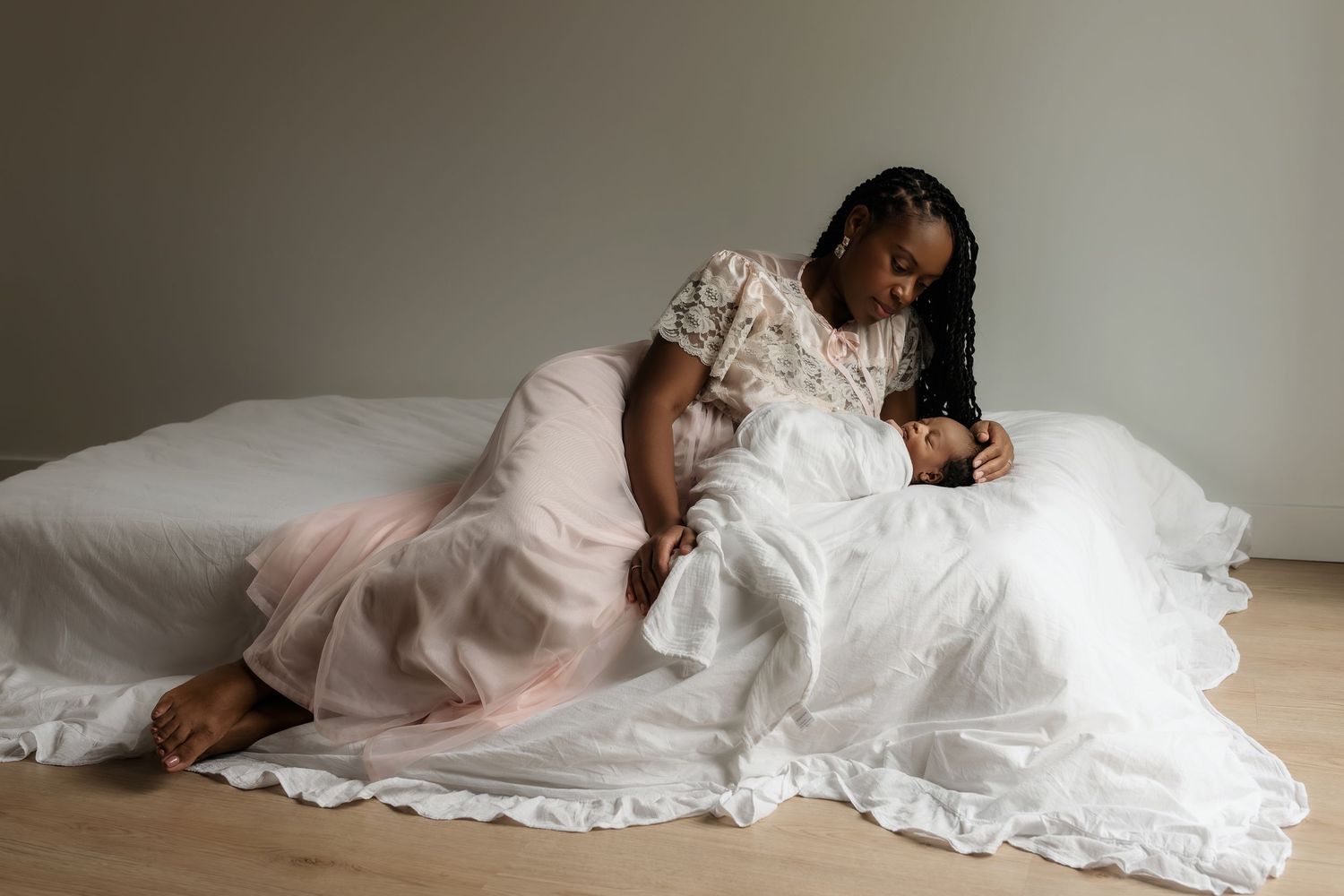 Heart and Gable newborn photography of baby wrapped in soft blanket, highlighting delicate details and innocence.