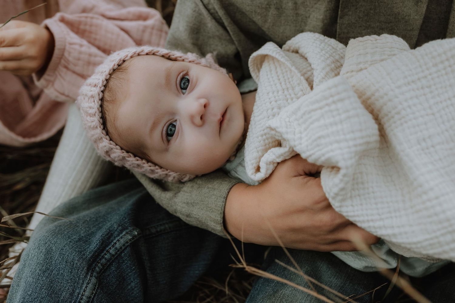 Heart and Gable newborn photography of baby wrapped in soft blanket, highlighting delicate details and innocence.