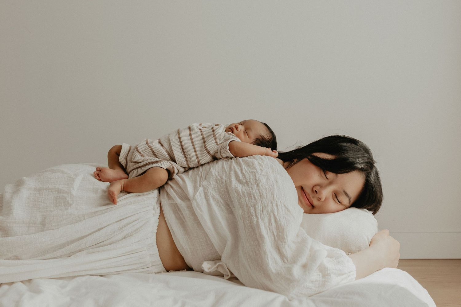 Adorable sleeping baby in cozy Edmonton studio setup, perfect example of newborn photography with soft lighting.