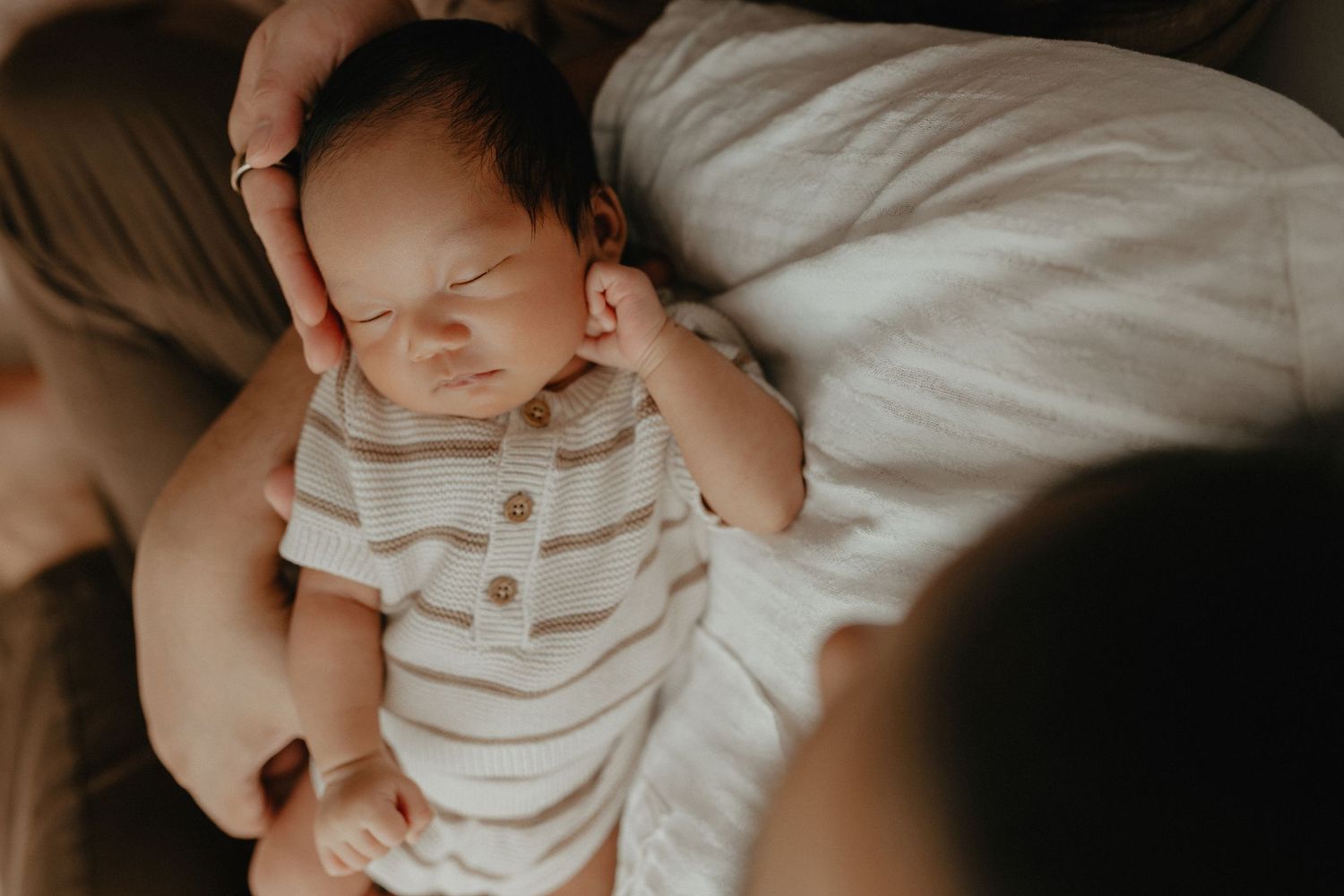 Sleeping newborn in studio photography session in Edmonton, Alberta, capturing peaceful early life moments.