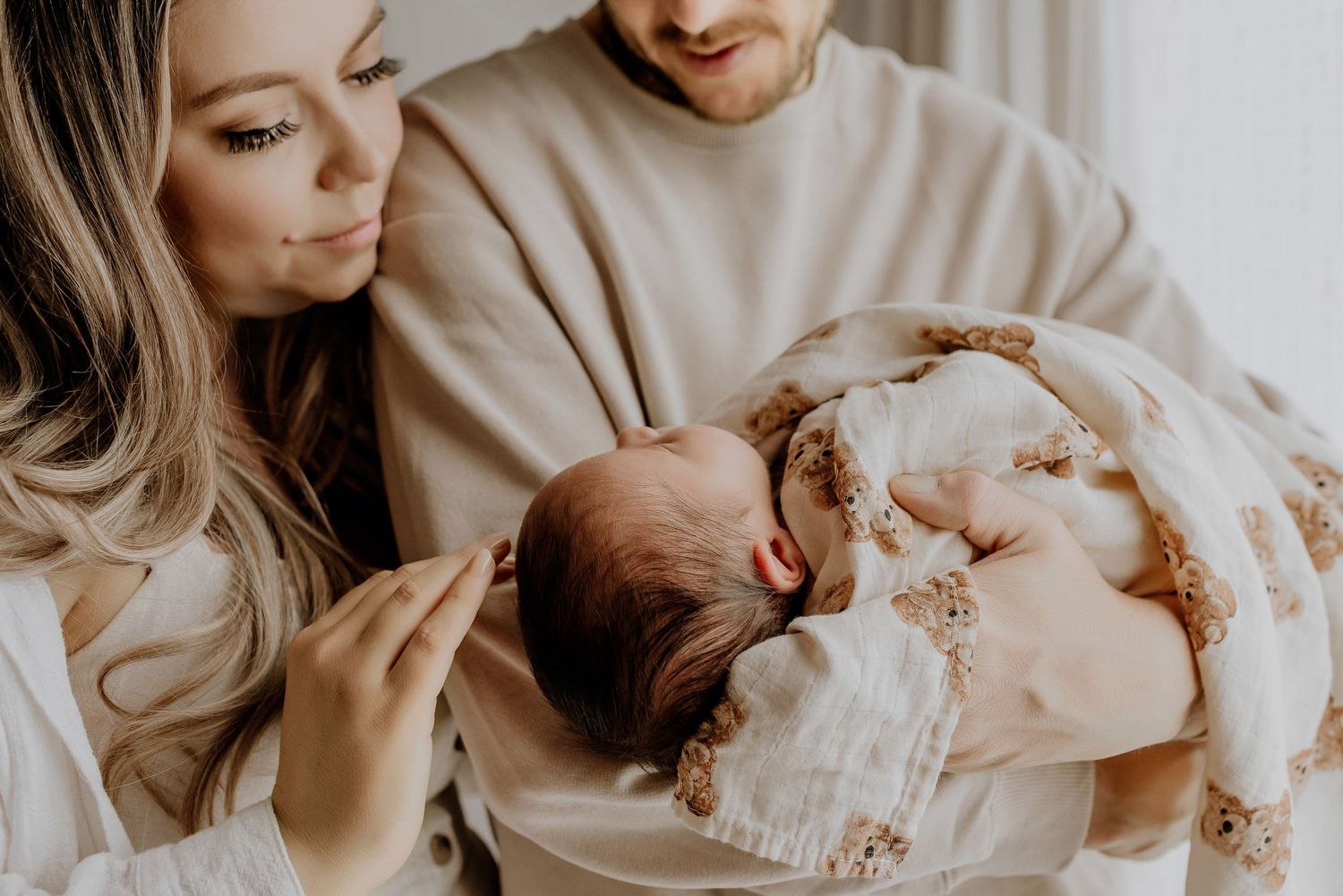 Heart and Gable newborn photography of baby wrapped in soft blanket, highlighting delicate details and innocence.