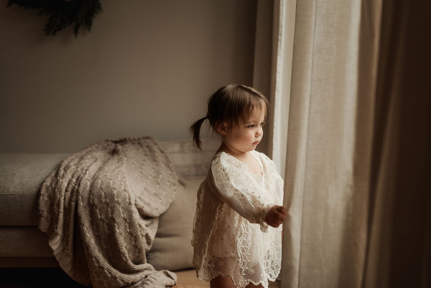 Family photography session in Edmonton, Alberta, capturing children enjoying light-filled portraits.