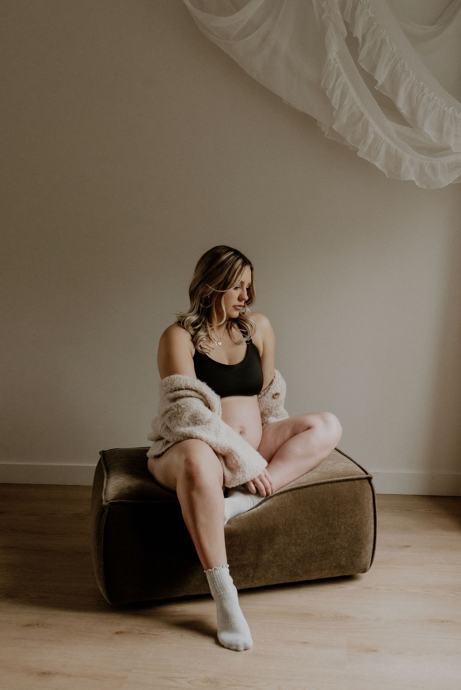 Studio maternity portrait of expecting mother in Edmonton, Alberta, showcasing elegant and timeless pregnancy photos.