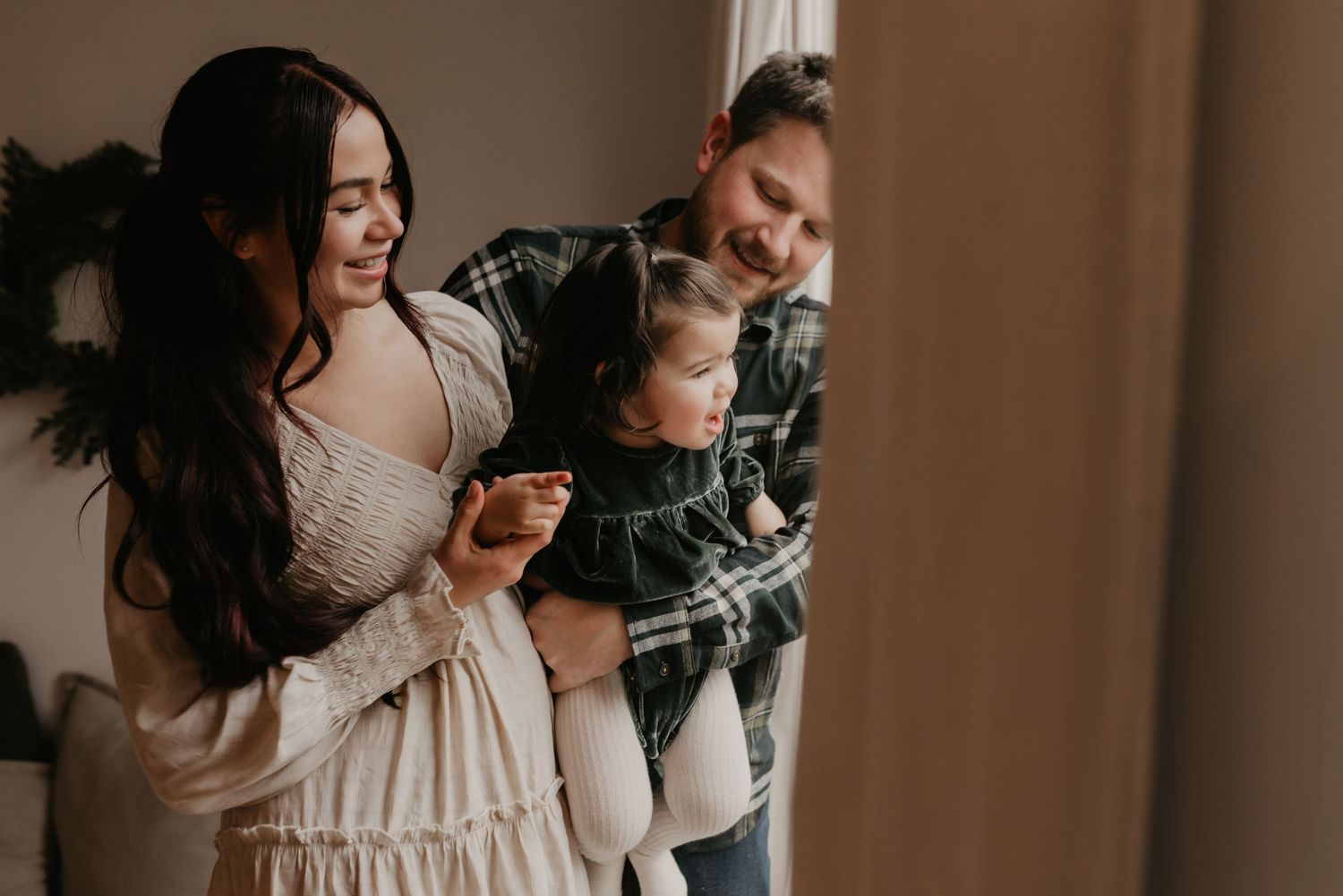 Family photography session in Edmonton, Alberta, capturing parents and children enjoying light-filled portraits.