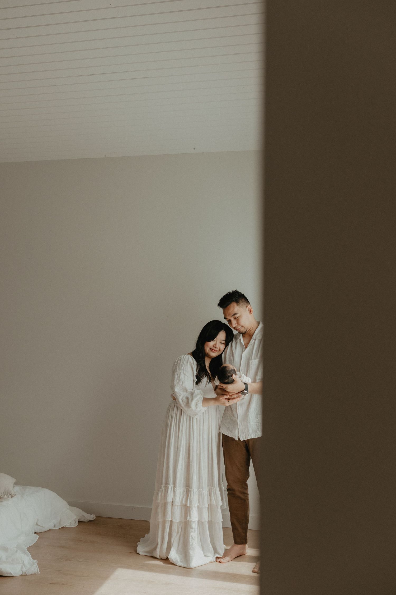 Adorable sleeping baby in cozy Edmonton studio setup, perfect example of newborn photography with soft lighting.