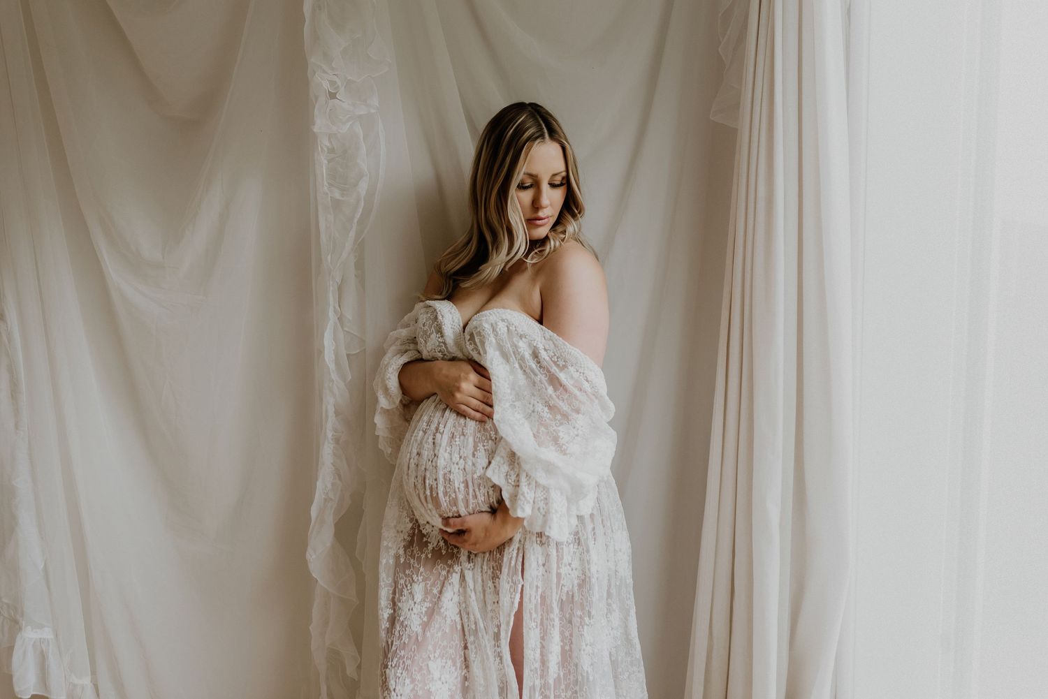 Studio maternity portrait of expecting mother in Edmonton, Alberta, showcasing elegant and timeless pregnancy photos.