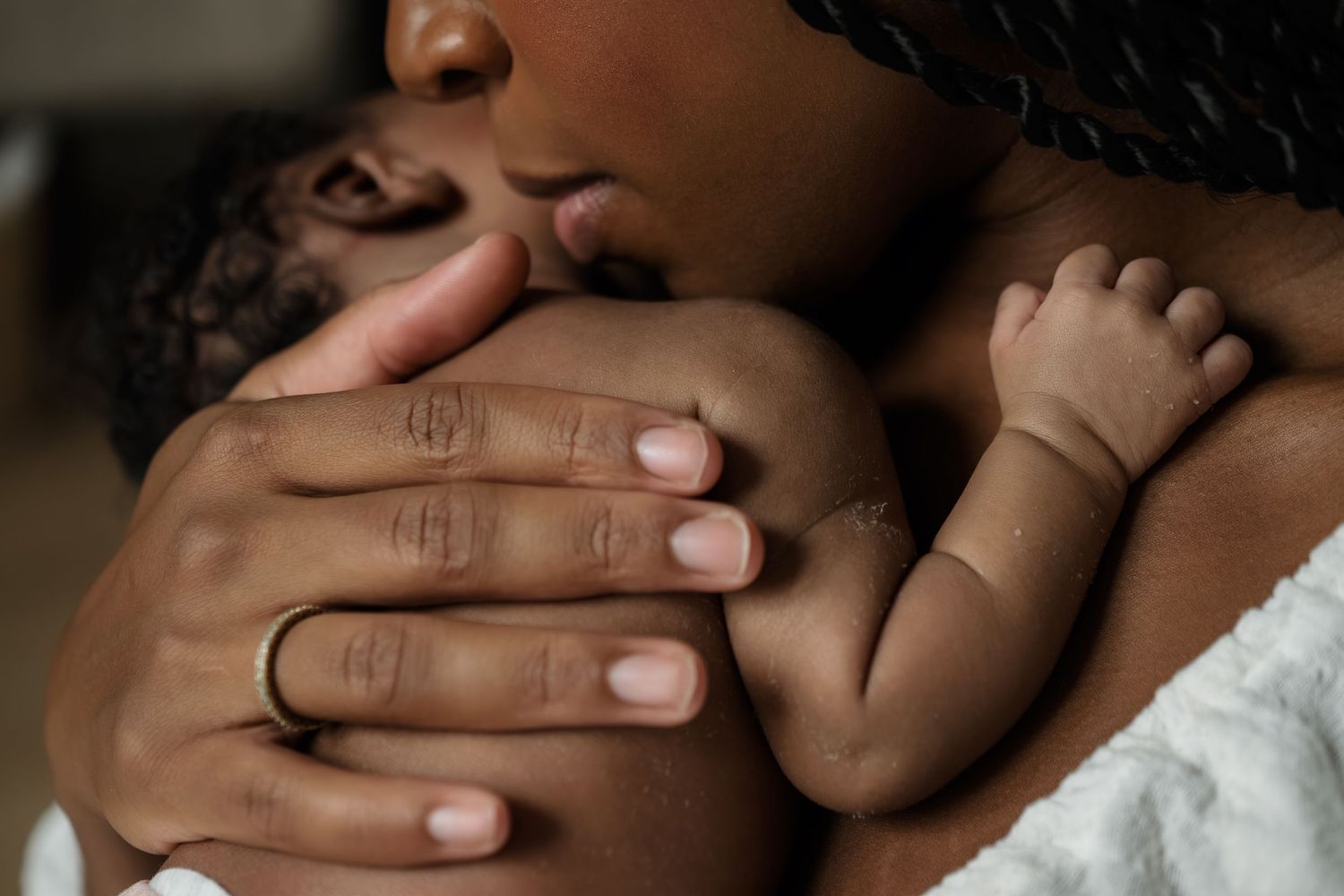 Close-up of newborn hands and feet in Edmonton studio, showcasing professional newborn photography style.