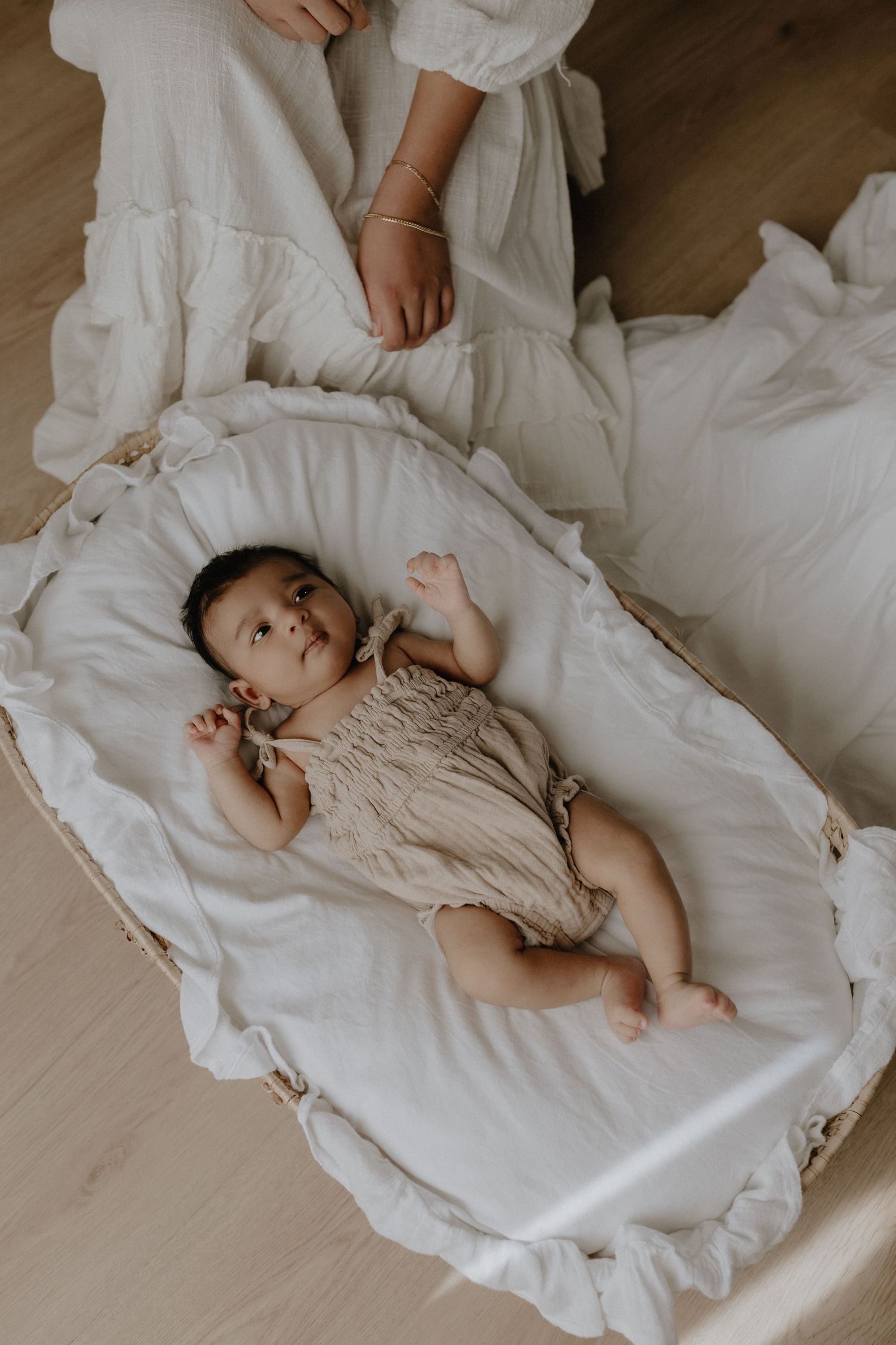 Adorable sleeping baby in cozy Edmonton studio setup, perfect example of newborn photography with soft lighting.