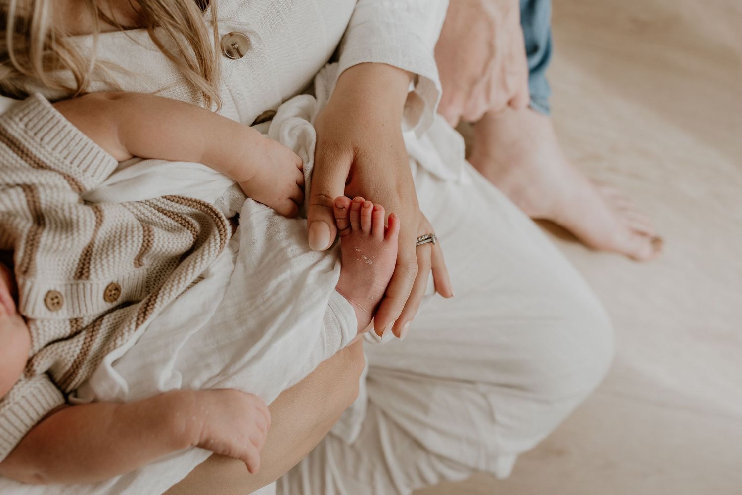 Close-up of newborn hands and feet in Edmonton studio, showcasing professional newborn photography style.