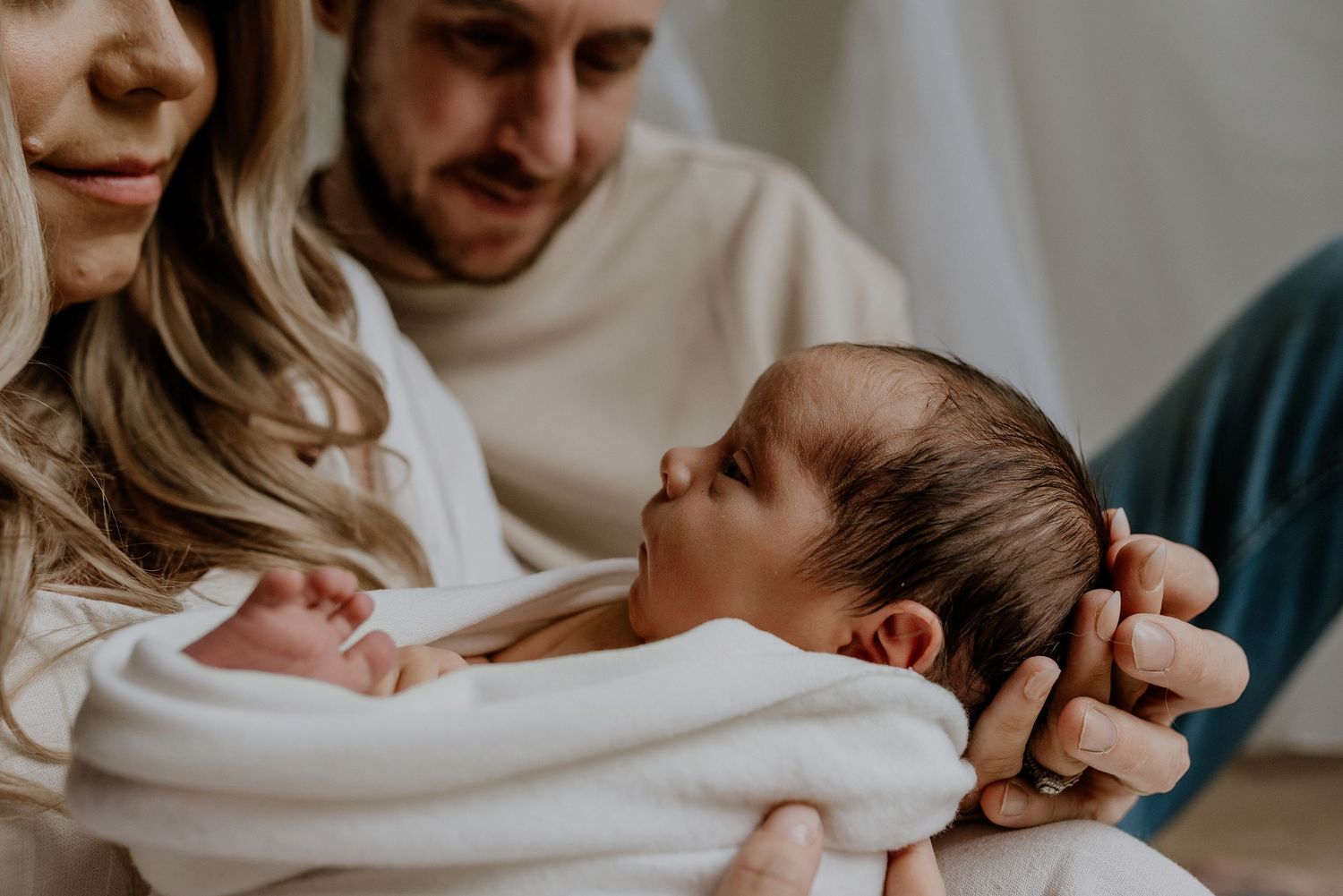 Close-up of newborn hands and feet in Edmonton studio, showcasing professional newborn photography style.