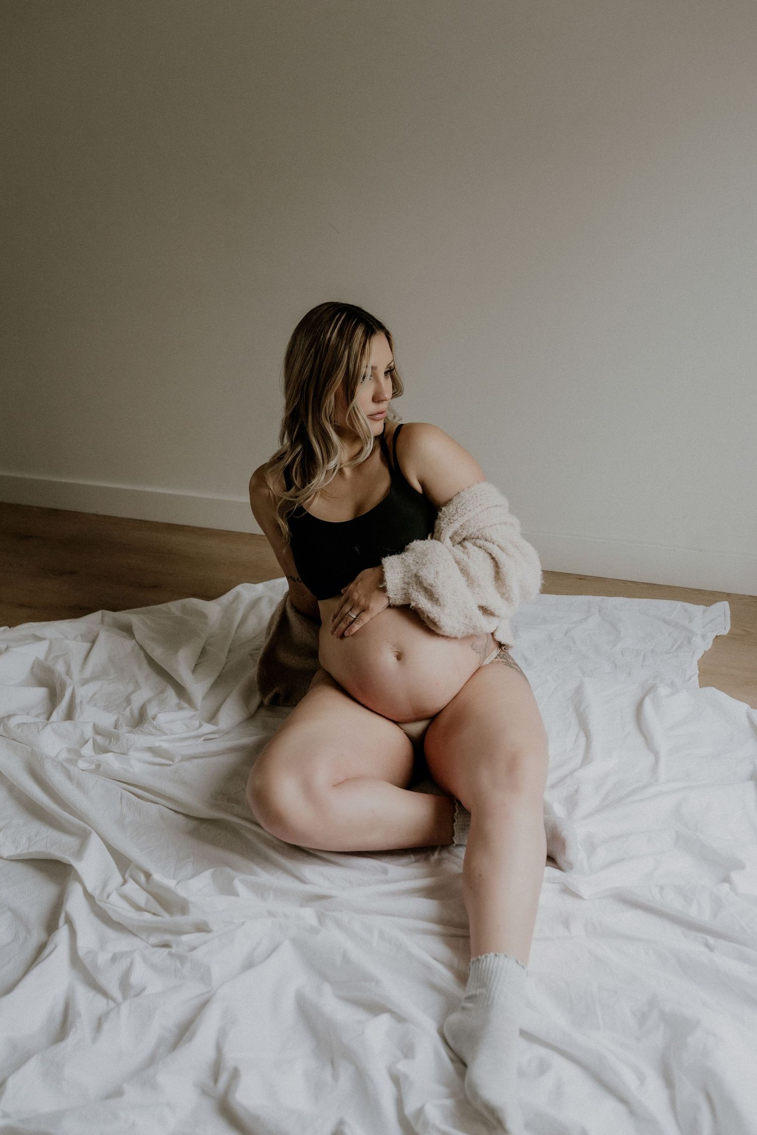 Studio maternity portrait of expecting mother in Edmonton, Alberta, showcasing elegant and timeless pregnancy photos.