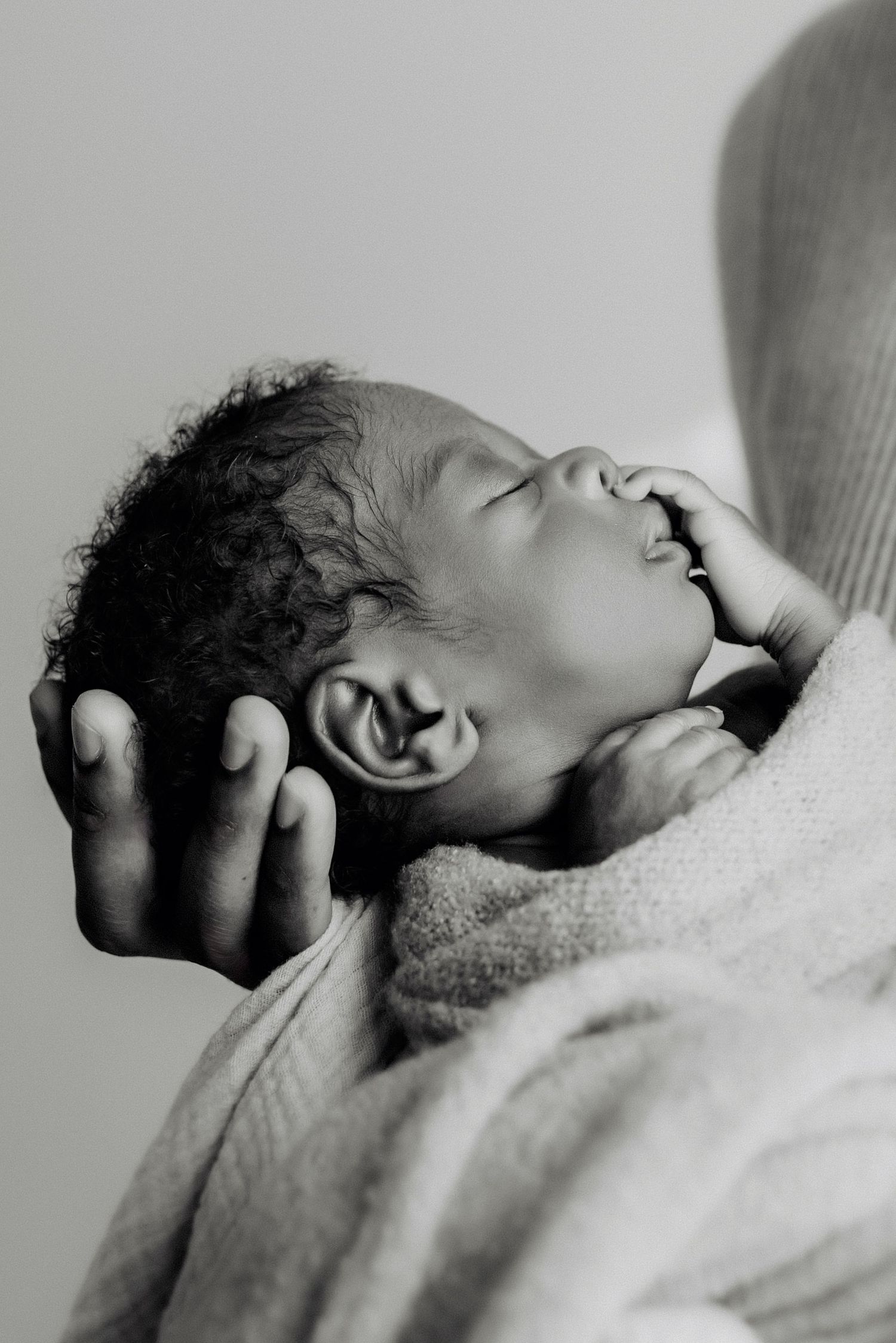 Sleeping newborn in studio photography session in Edmonton, Alberta, capturing peaceful early life moments.