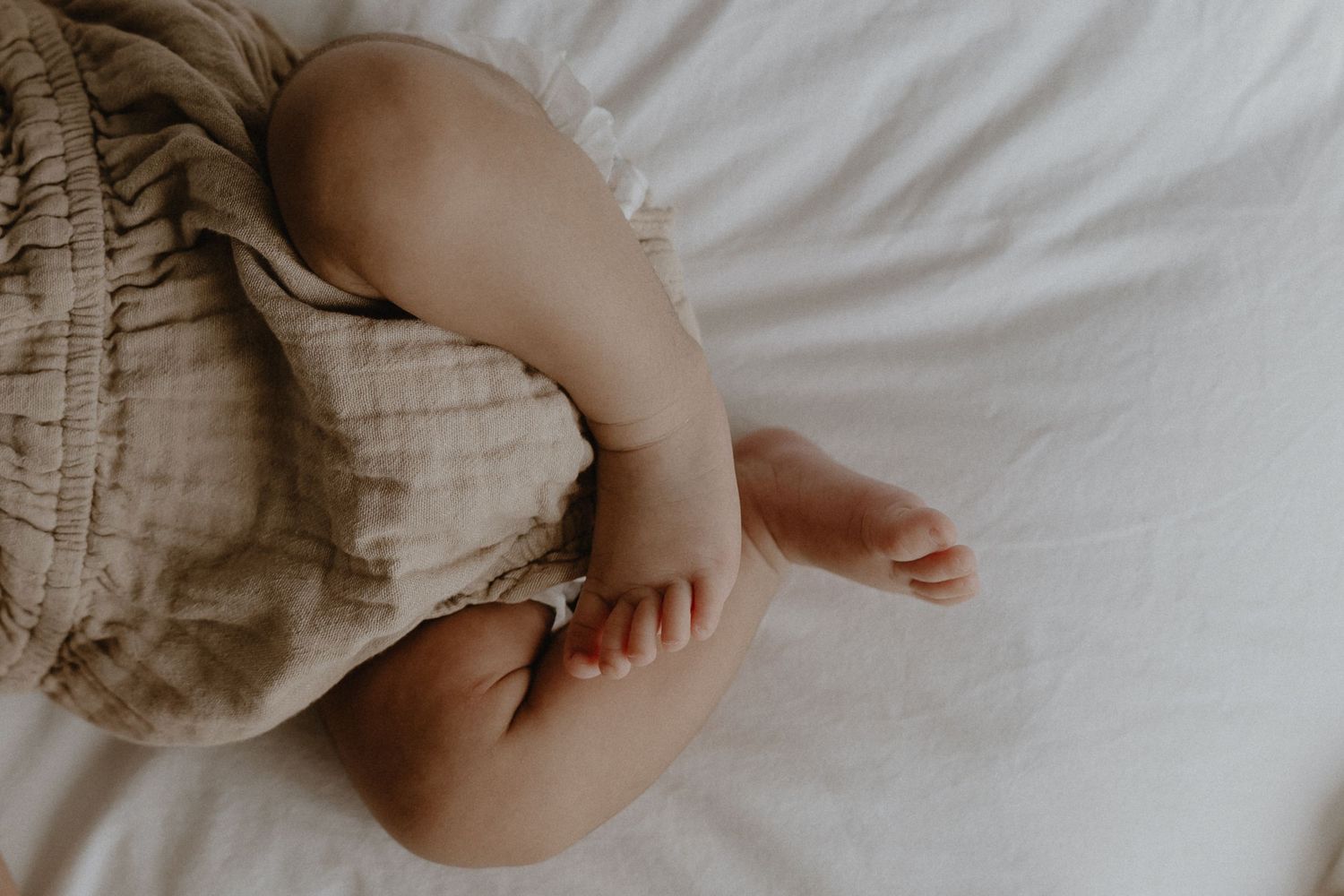 Close-up of newborn hands and feet in Edmonton studio, showcasing professional newborn photography style.