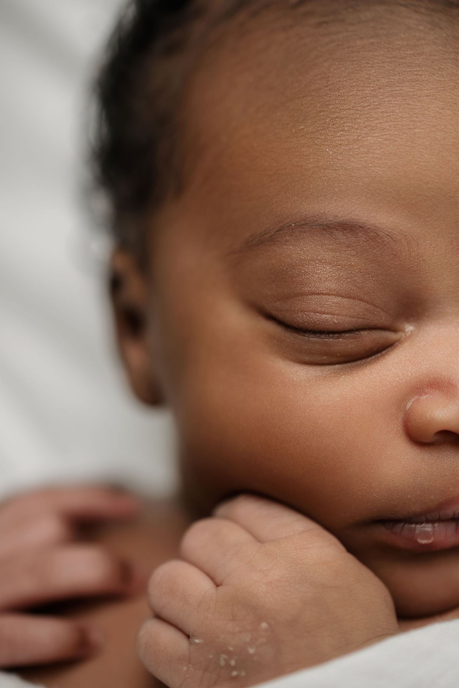 Close-up of newborn hands and feet in Edmonton studio, showcasing professional newborn photography style.