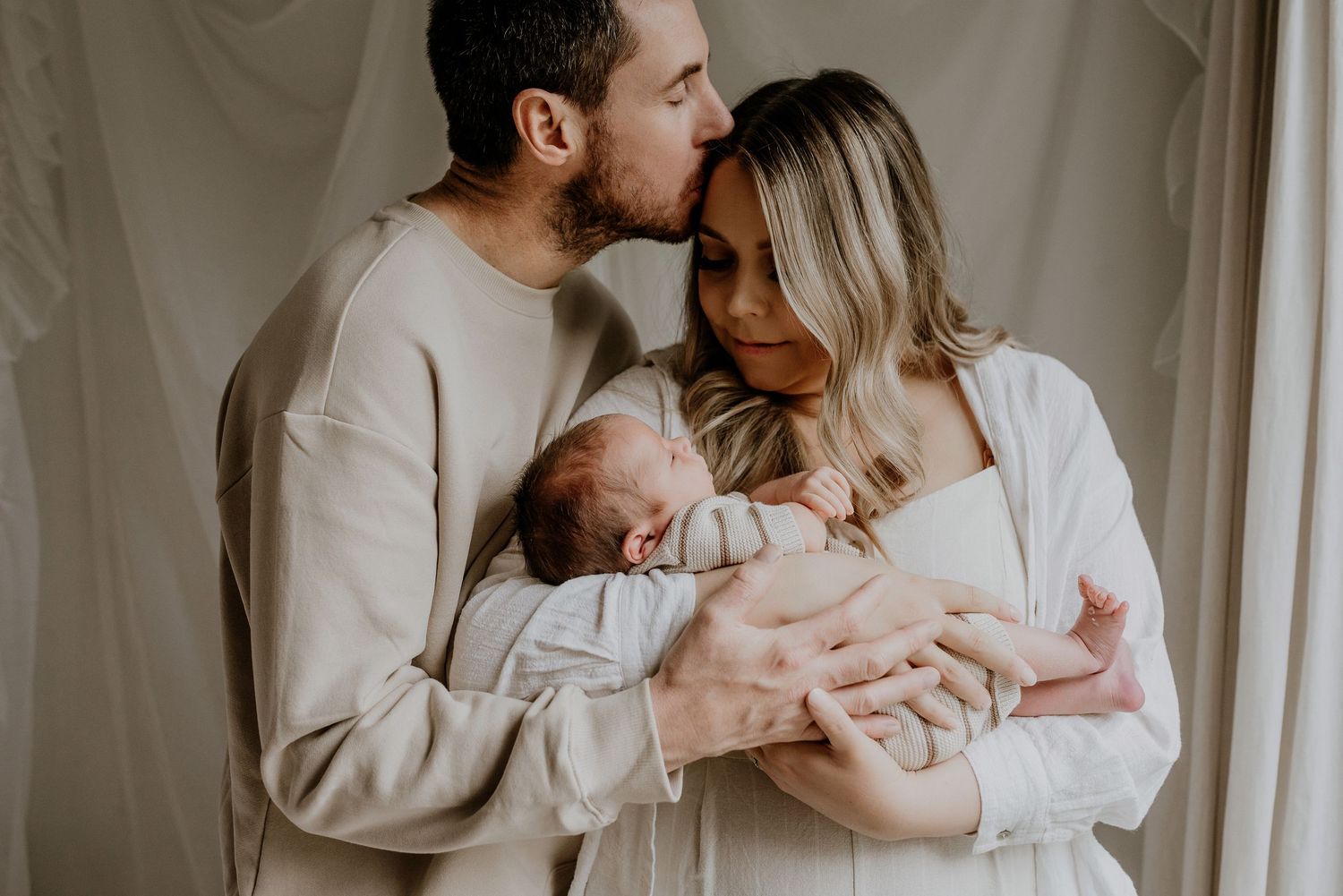 Close-up of newborn hands and feet in Edmonton studio, showcasing professional newborn photography style.