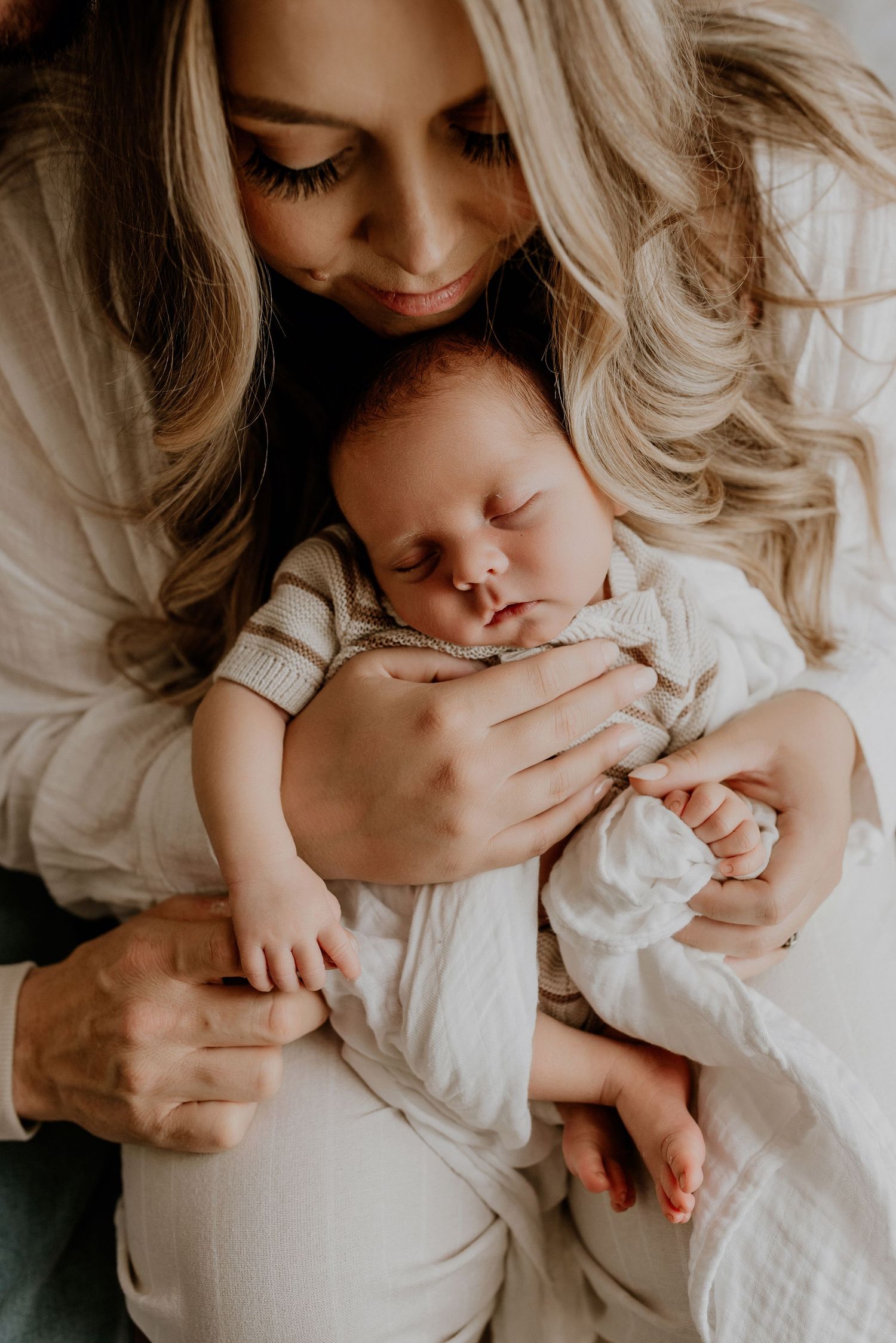 Close-up of newborn hands and feet in Edmonton studio, showcasing professional newborn photography style.