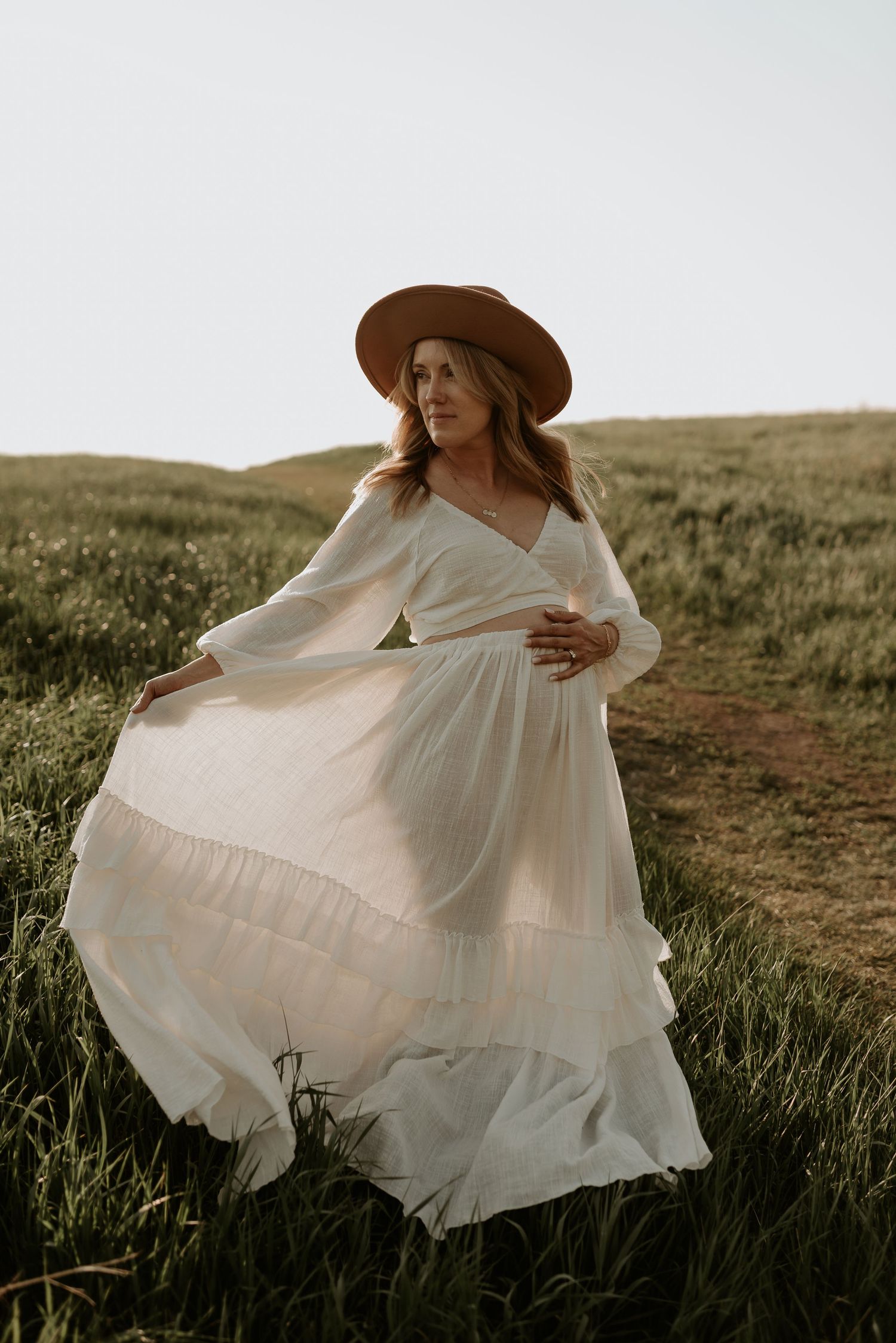 Edmonton maternity photography session of pregnant woman in soft natural light, capturing her pregnancy glow.