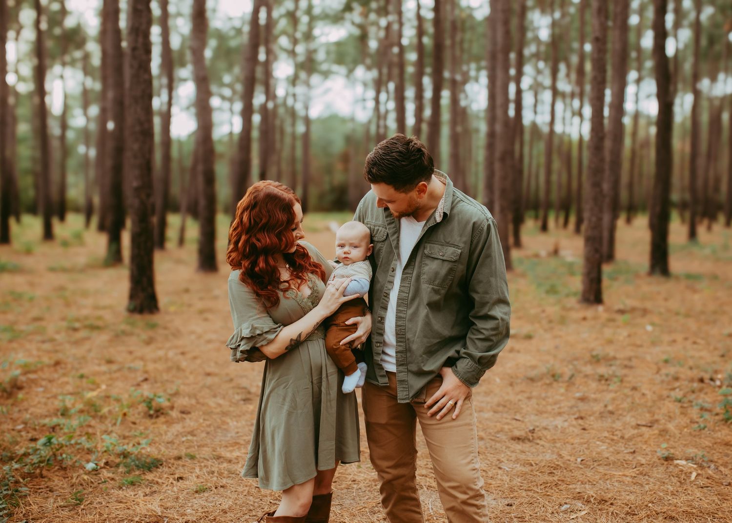 A romantic couple shares an intimate moment together in a serene pine forest during golden hour.