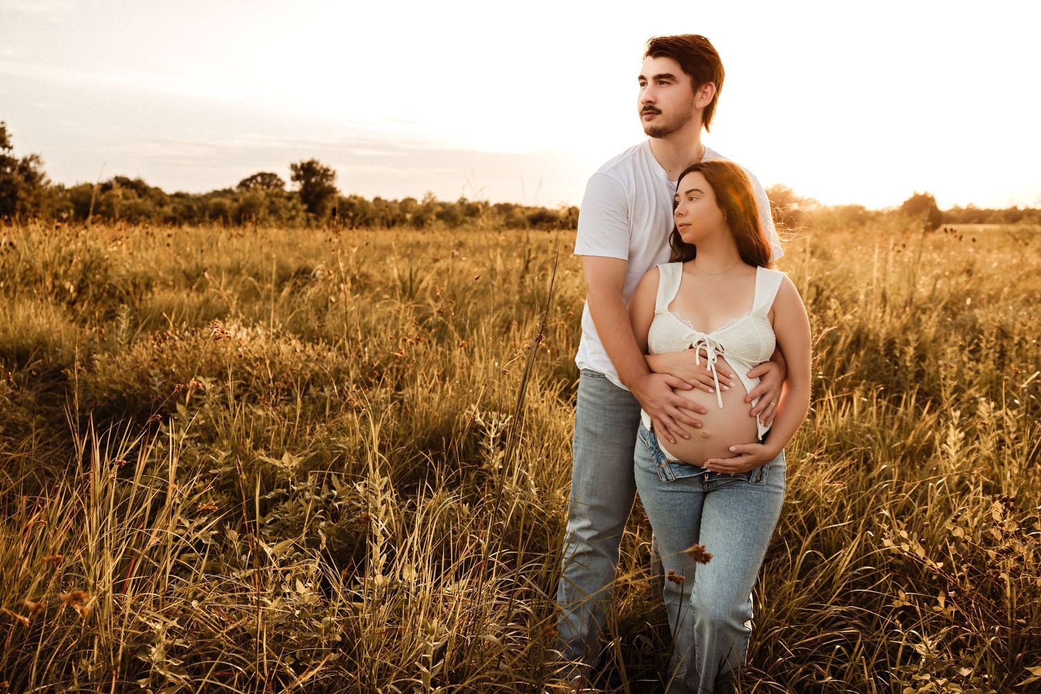 A couple shares romantic moments in a golden wheat field during sunset, captured in multiple candid shots.