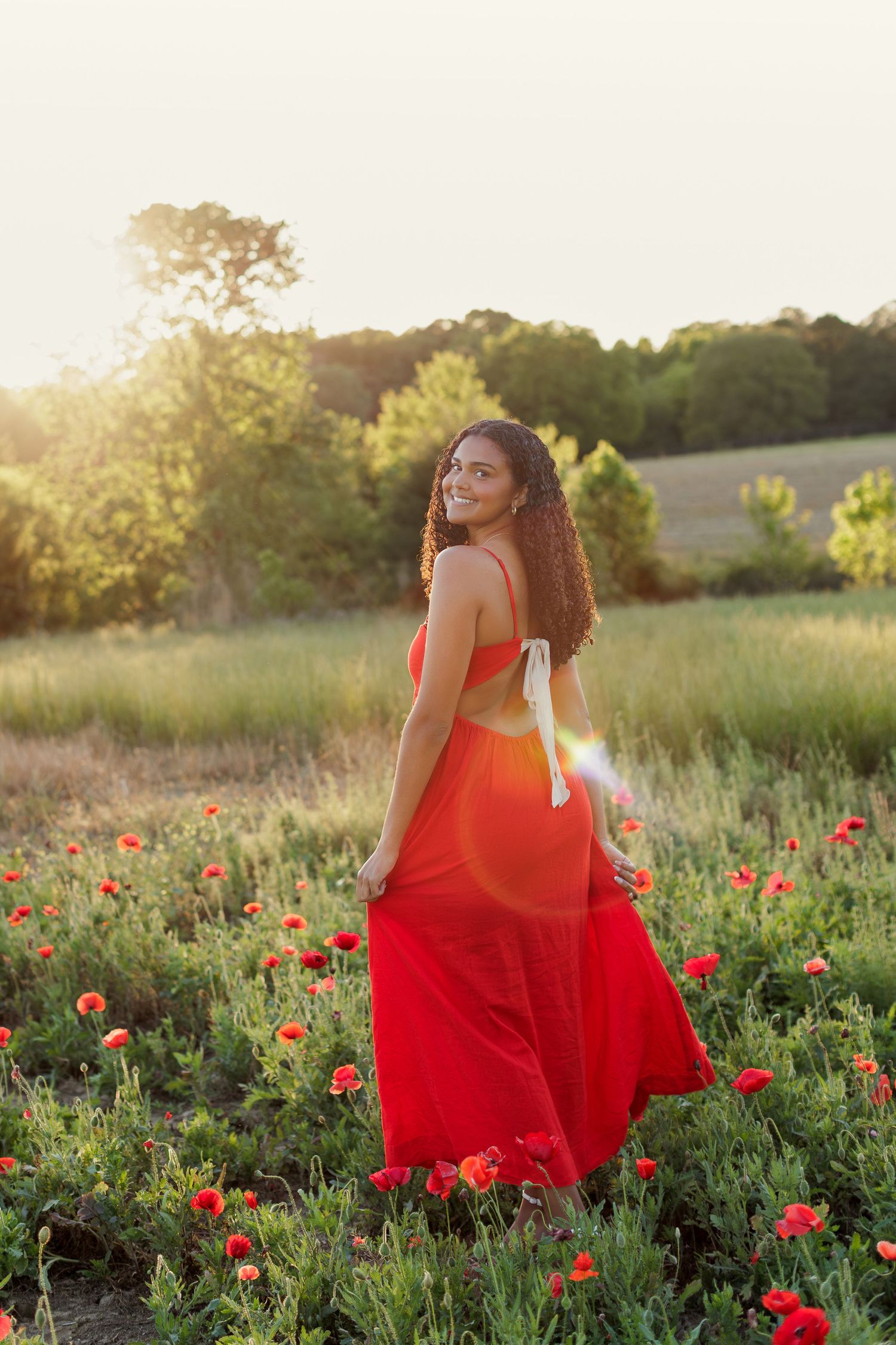Wake Forest Senior Session at Juniper Creek Farm in wildflower field during golden hour in Raleigh, NC.