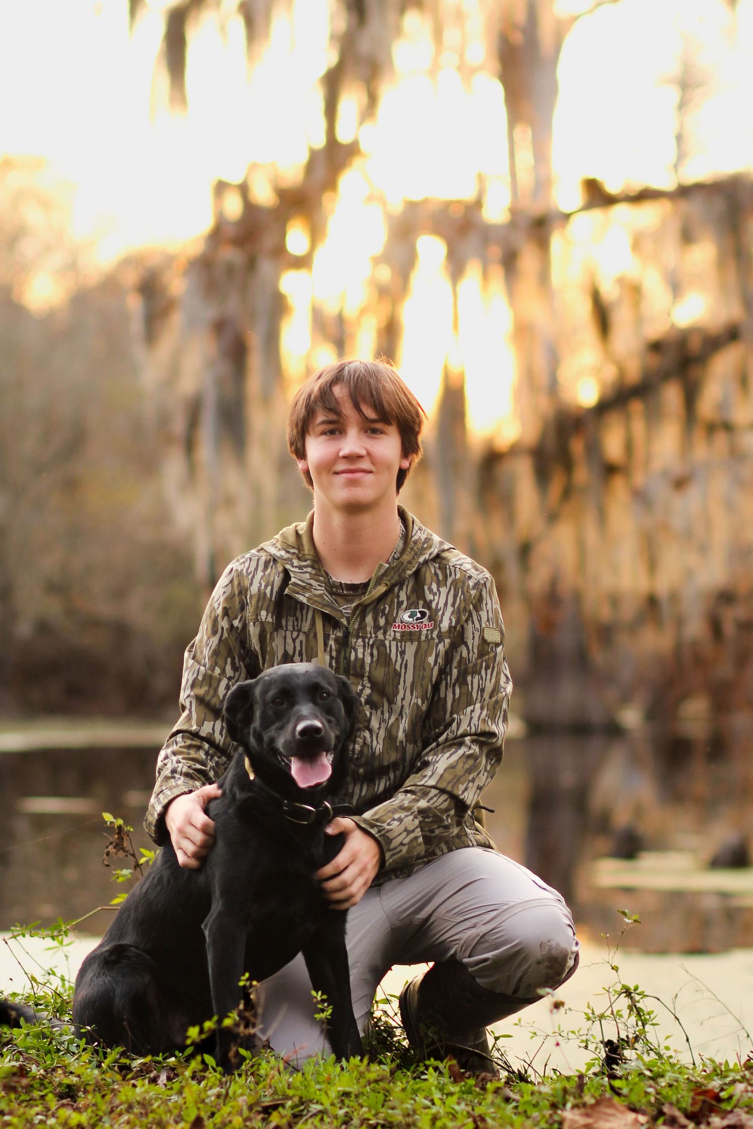 High School Senior Portraits in Eastern NC at hunting club with dog.