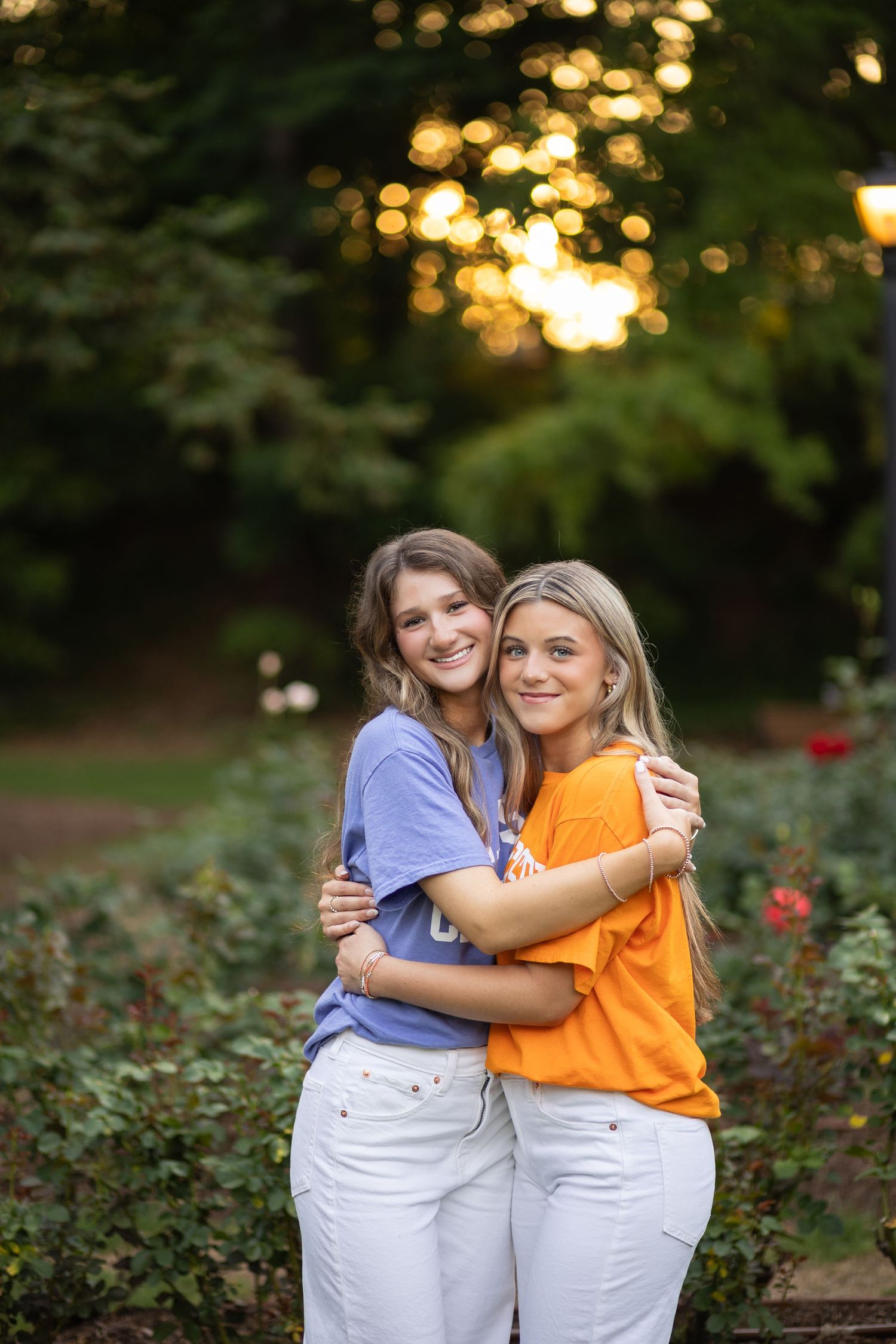 High School Senior Best Friends Portraits wearing college decision t-shirts at Rose Garden in Raleigh, NC