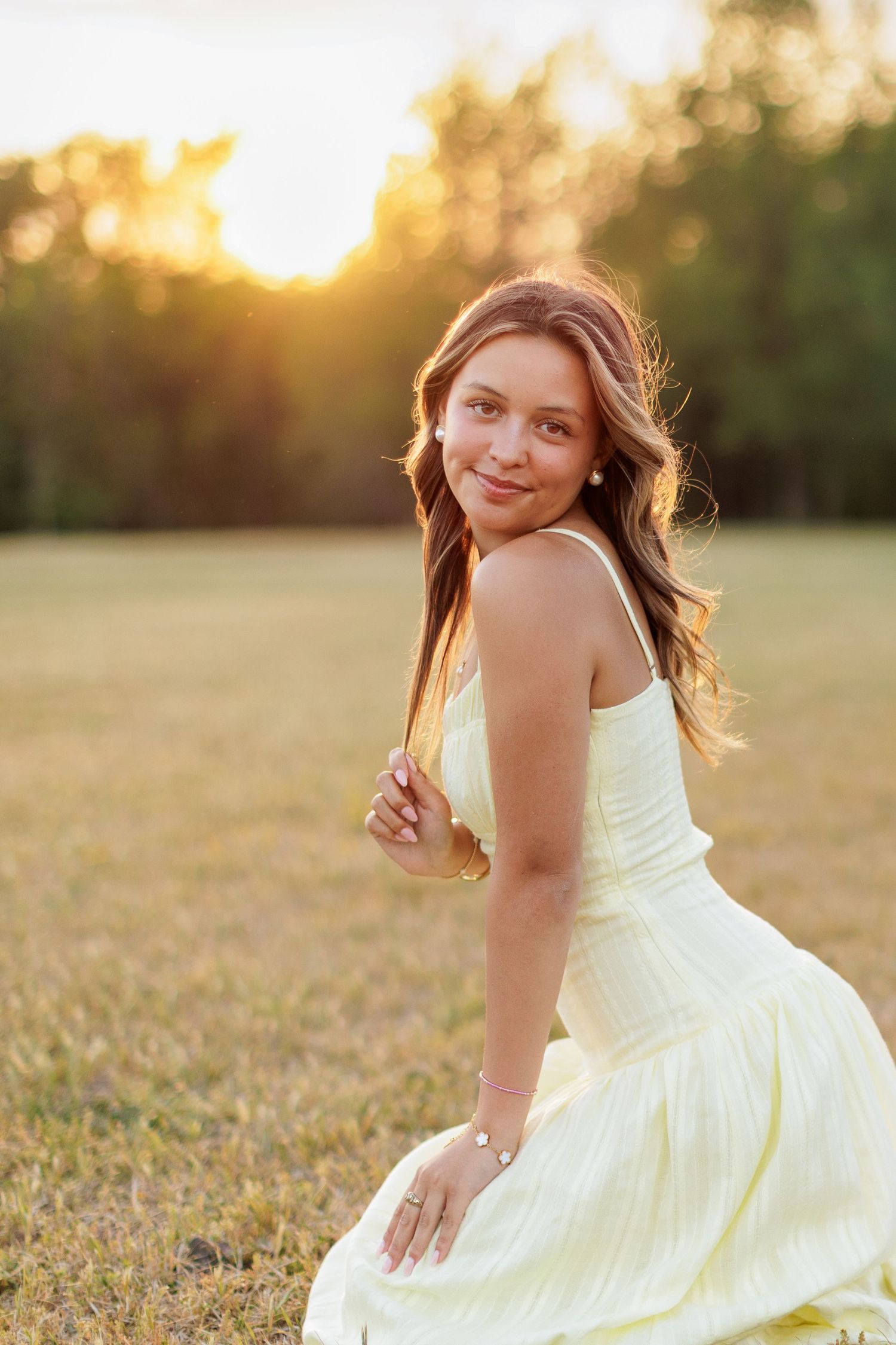 Wake Forest Senior Session at Horseshoe Farm at golden hour in field in Raleigh, NC.