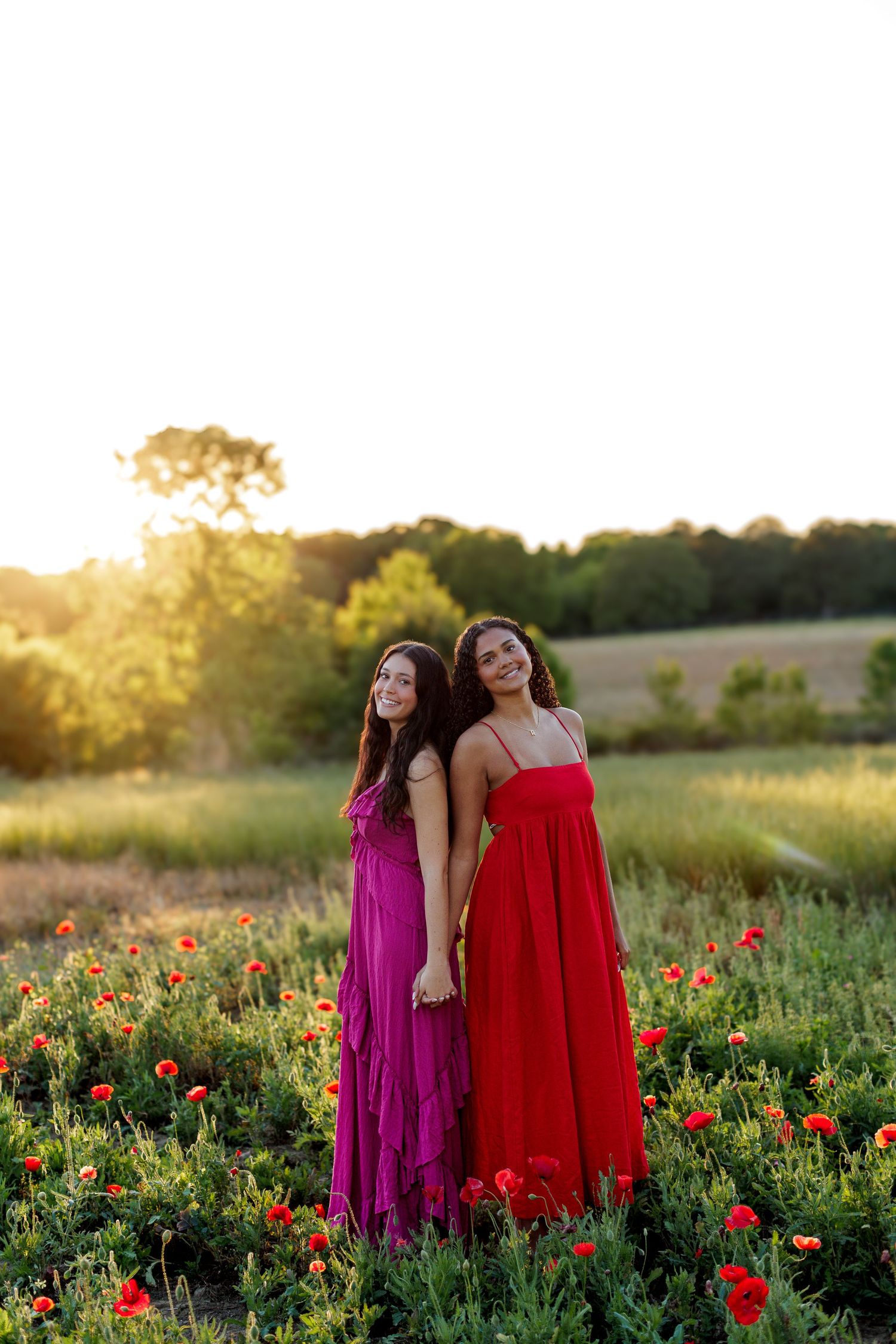 Wake Forest Senior Best Friend Session at Juniper Creek Farm in wildflower field during golden hour in Raleigh, NC.