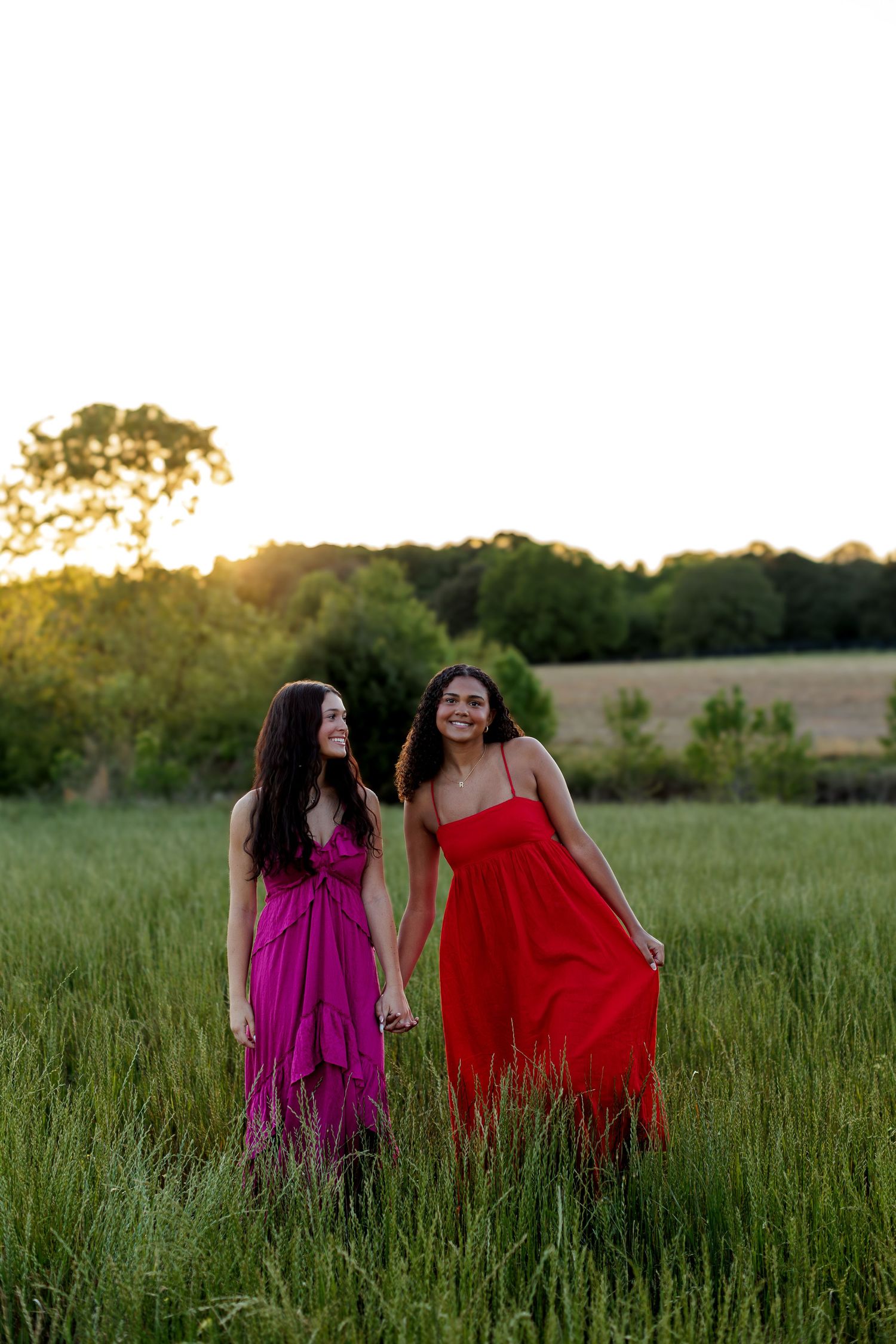 Wake Forest Senior Best Friend Session at Juniper Creek Farm in wildflower field during golden hour in Raleigh, NC.