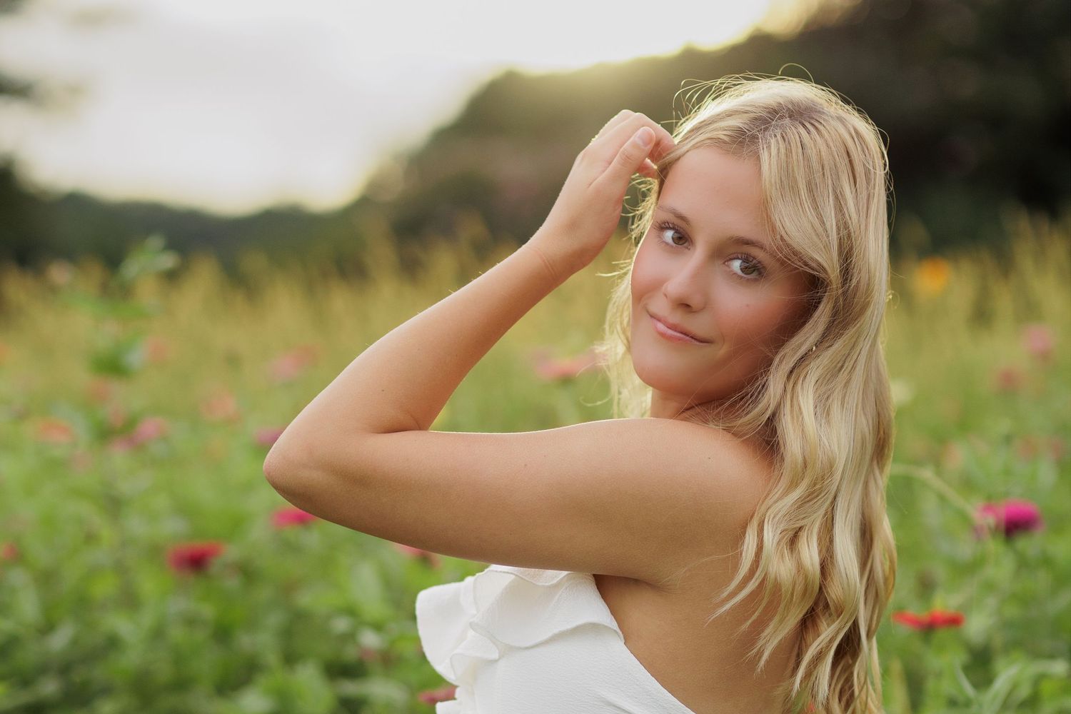 Wake Forest Senior Photography in a flower field at Dix Park in Raleigh, NC golden hour