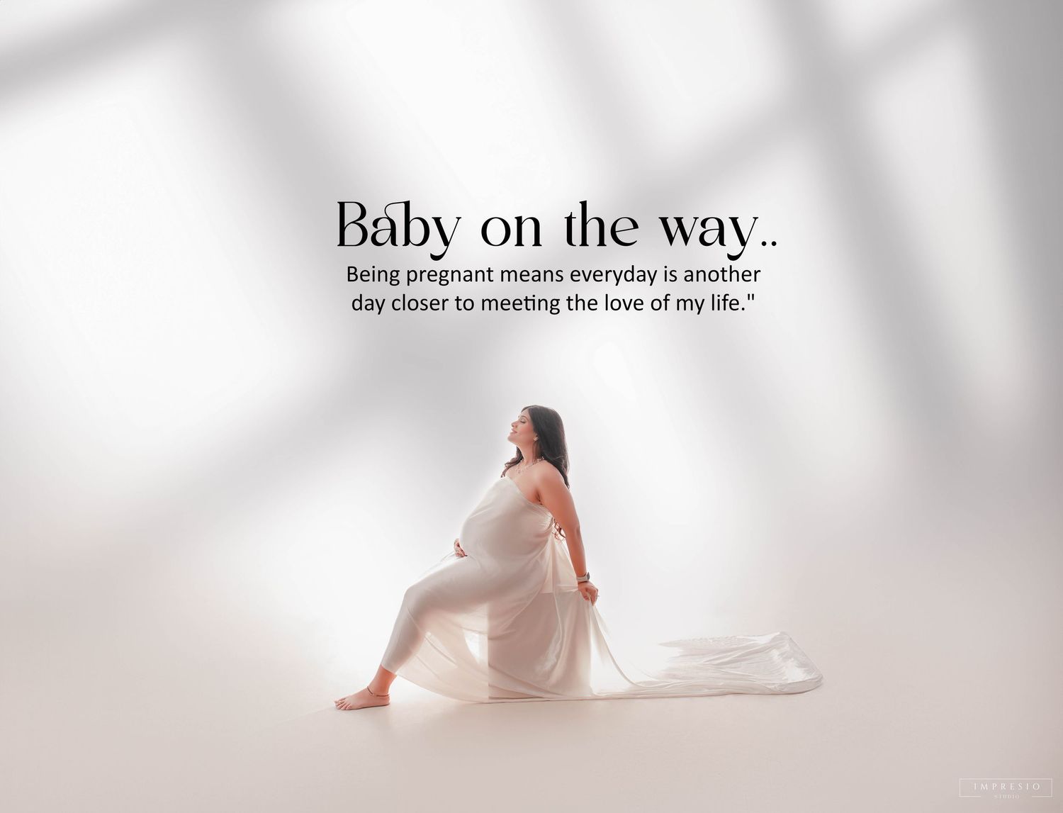 Minimalist pregnancy announcement banner with text and soft lighting.