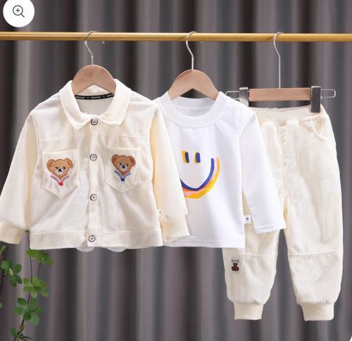 Three-piece white children's outfit set with smiley face and bear motifs.