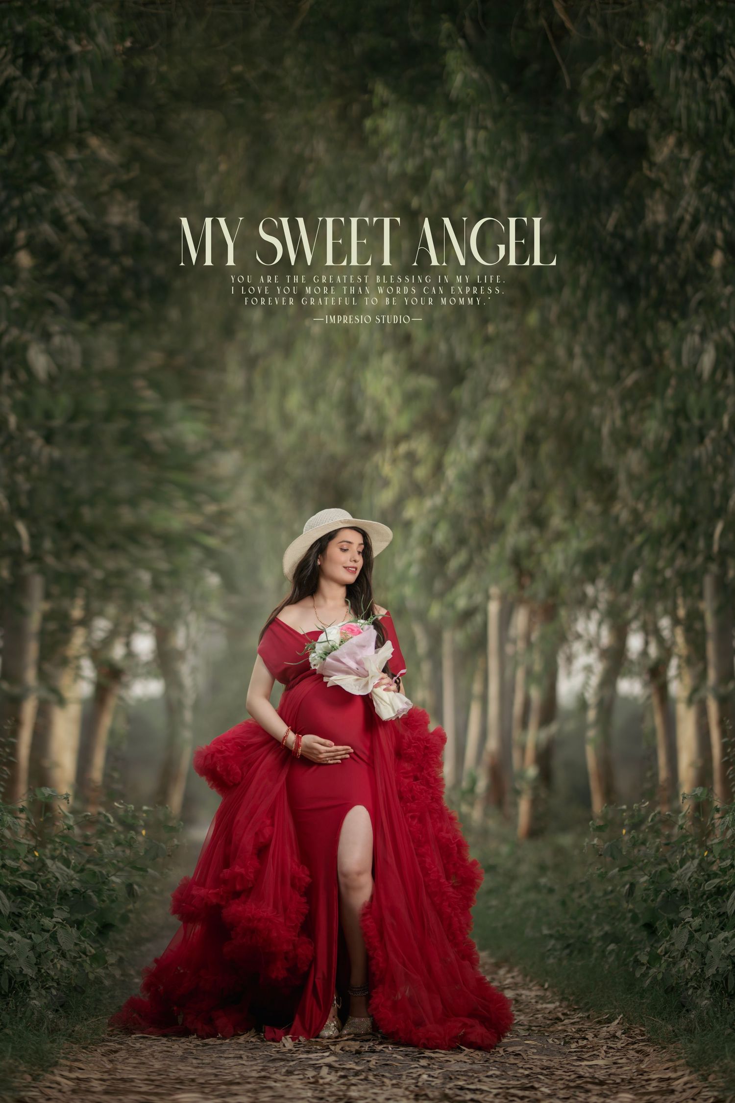 A romantic forest maternity photo featuring a red tulle gown and white flowers.