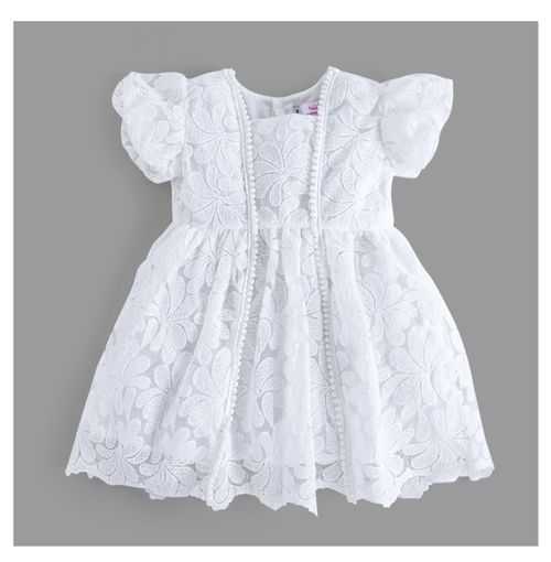 Full view of white lace baby dress with flutter sleeves and scalloped hem.