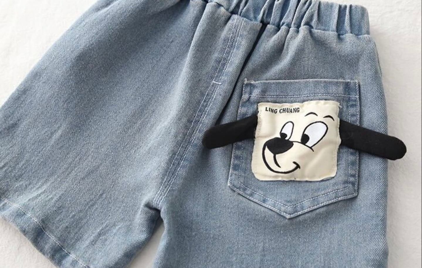 Close-up photos showing details of light blue denim jeans including pockets, stitching, and a smiley face patch detail.