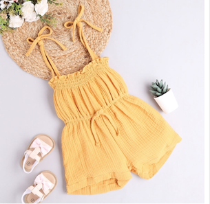 Yellow summer romper with bow details displayed on a white background.