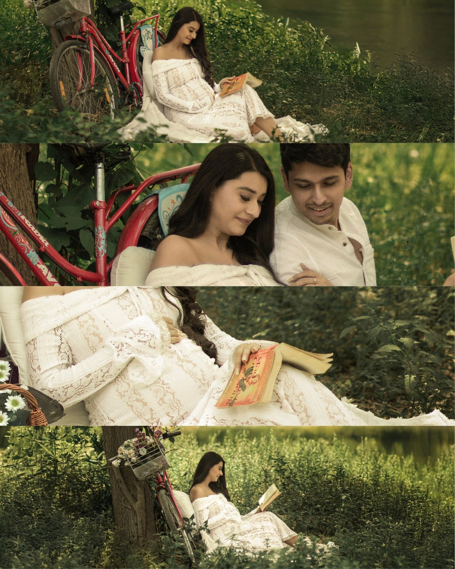 A couple in white outfits reading a book together outdoors near a red bicycle surrounded by lush greenery.
