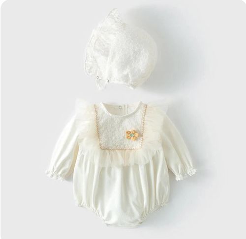Vintage-style ivory baby dress with ruffled details and delicate embroidery.