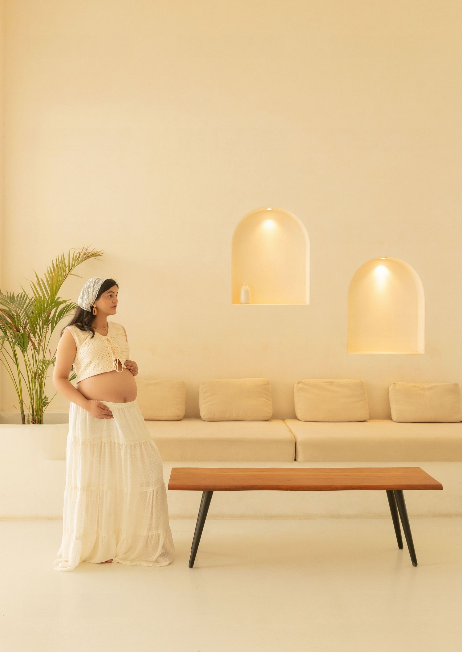 A sequence of aesthetic interior photos showing a minimalist wooden bench against a beige wall with pendant lighting.