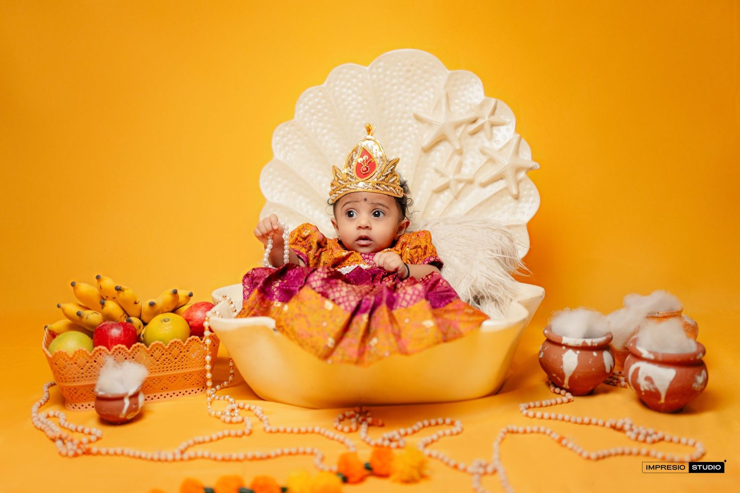A series of six connected orange-tinted baby photography scenes with props and decorative elements arranged horizontally.