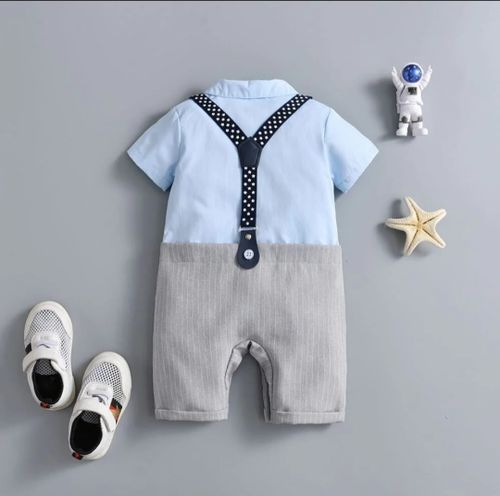 Baby boy outfit featuring light blue top and gray shorts with polka dot trim.