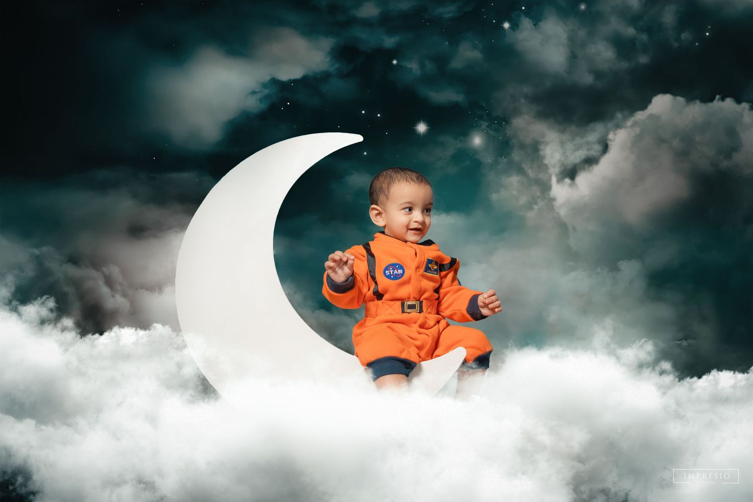 Baby in orange NASA astronaut suit sitting on crescent moon surrounded by clouds and stars in dreamy night sky.