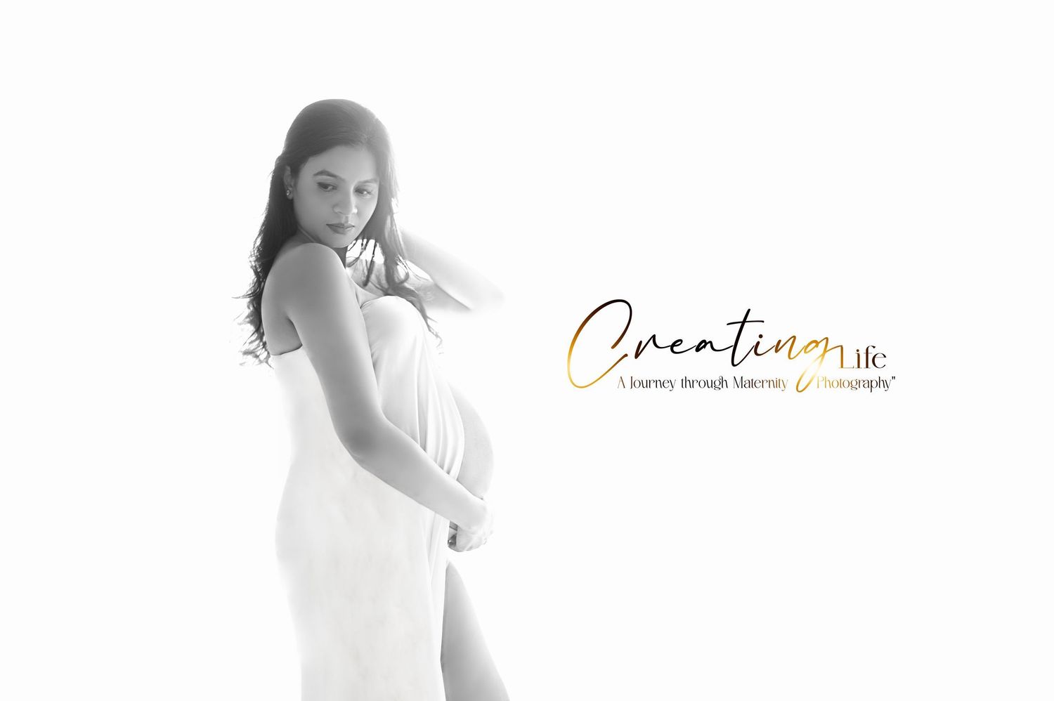 Clean white maternity studio photography with simple composition.