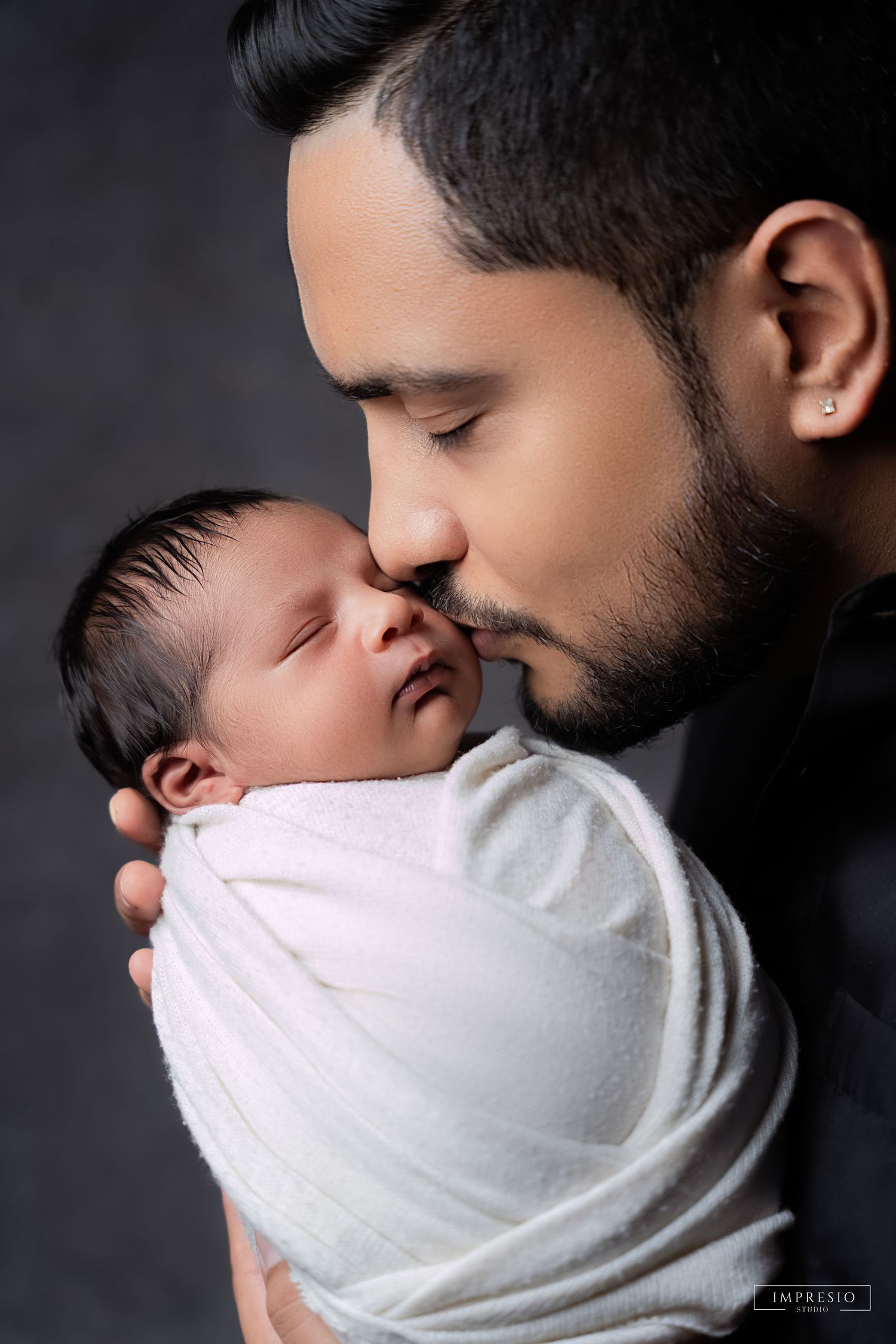 Baby boy in blue swaddle for professional newborn shoot – Impresio Studio