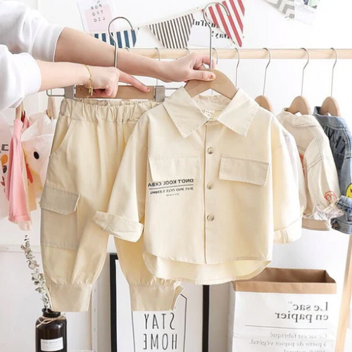 Two-piece beige toddler outfit with cargo pants and button-down shirt hanging on rack.