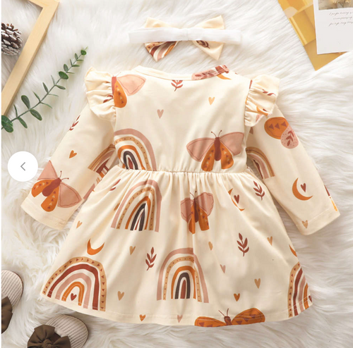 Cute baby dress with rainbow and boho patterns in cream and brown earth tones.
