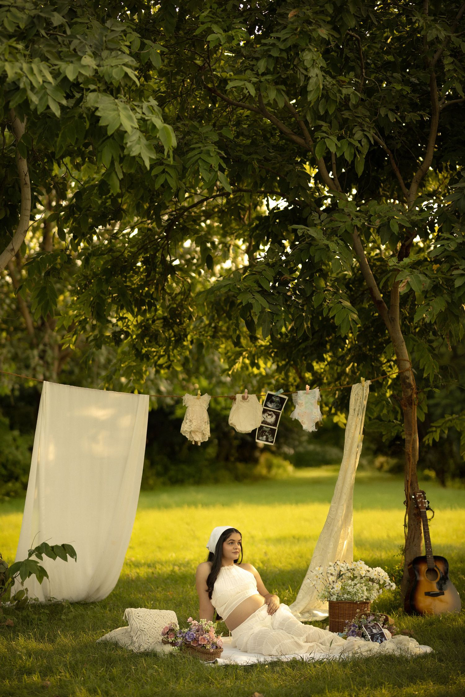 A dreamy outdoor scene with white linens hanging on a clothesline, flowers, and a guitar in a sunlit garden setting.
