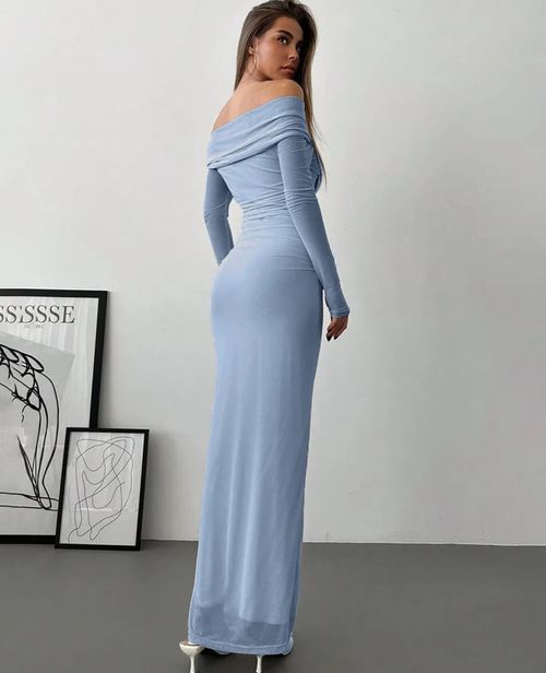 A long blue off-shoulder maxi dress shown from behind with framed artwork in the background.
