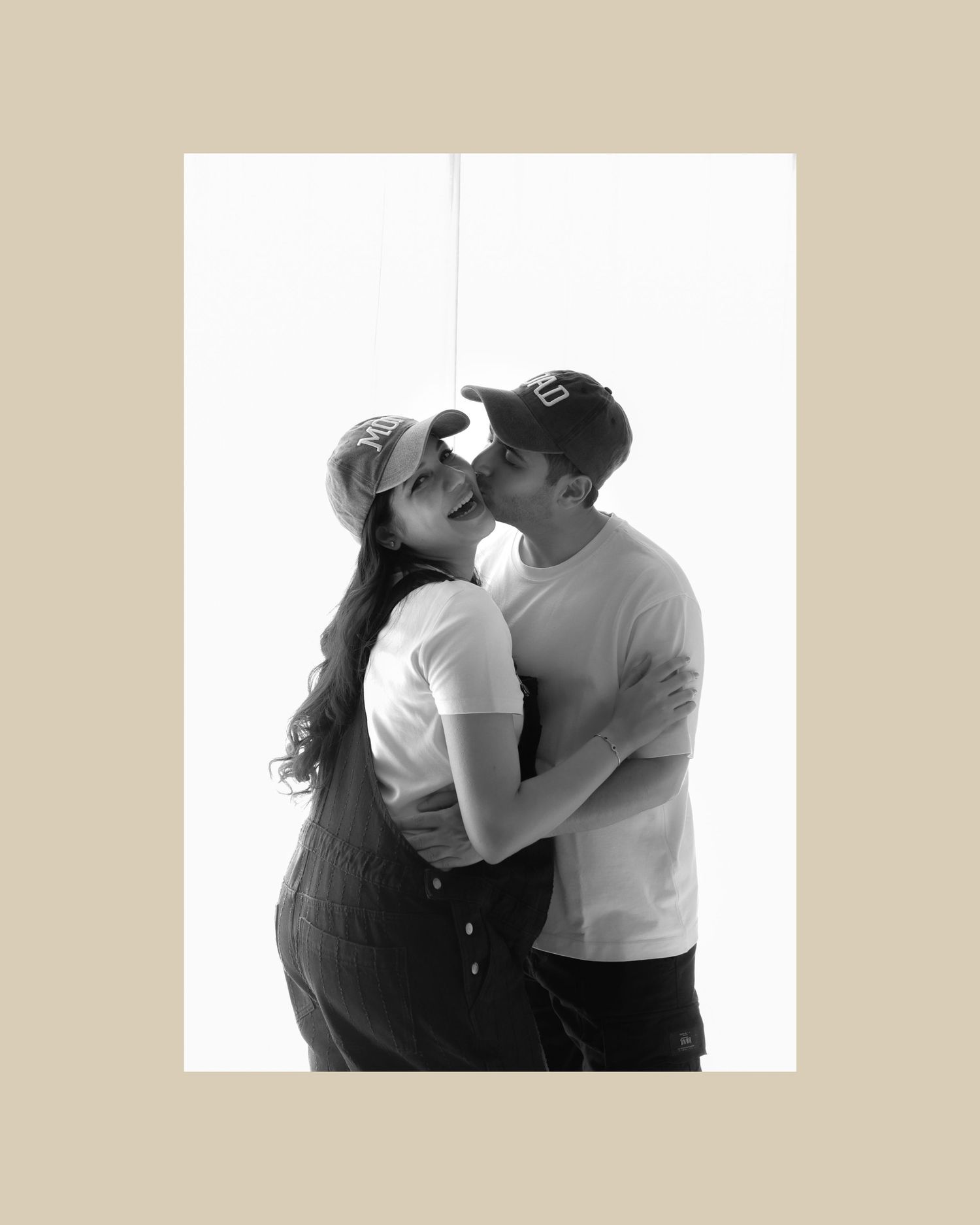 Black and white romantic couple portrait series showing intimate embraces and tender kisses in studio setting.