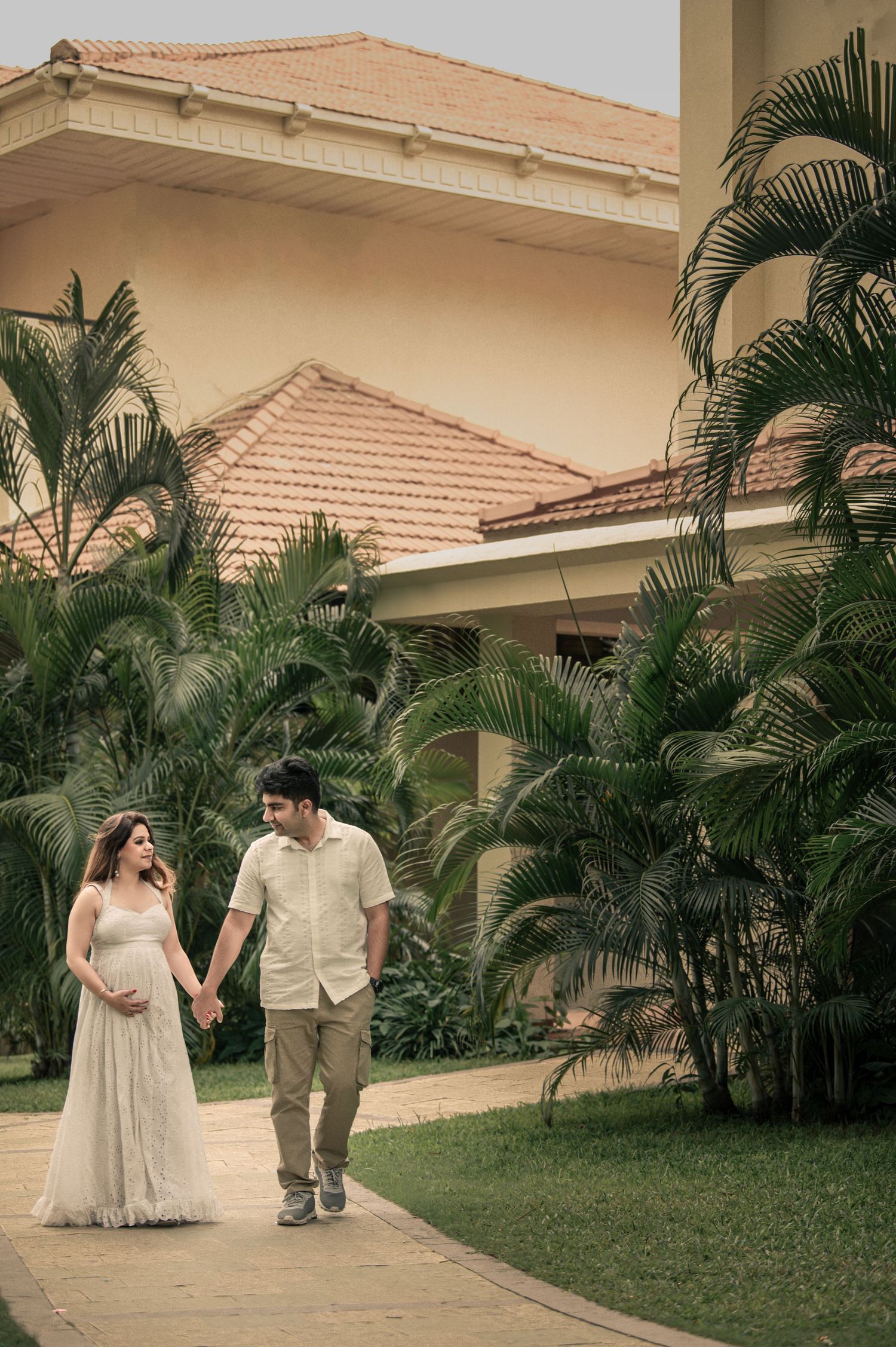 Joyful baby shower photoshoot with couple holding baby props – Impresio Studio